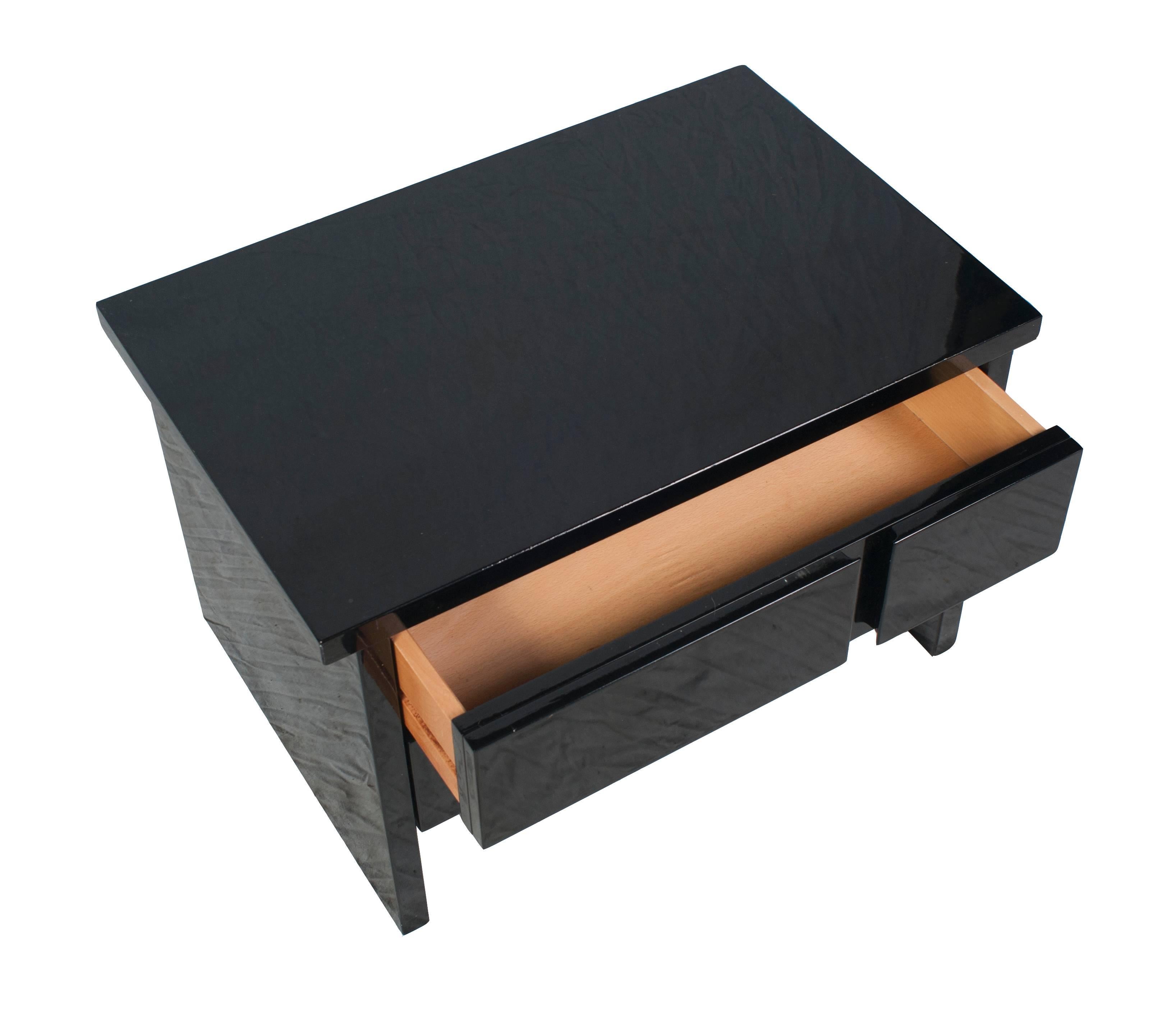A pair of black lacquer side tables or nightstands.