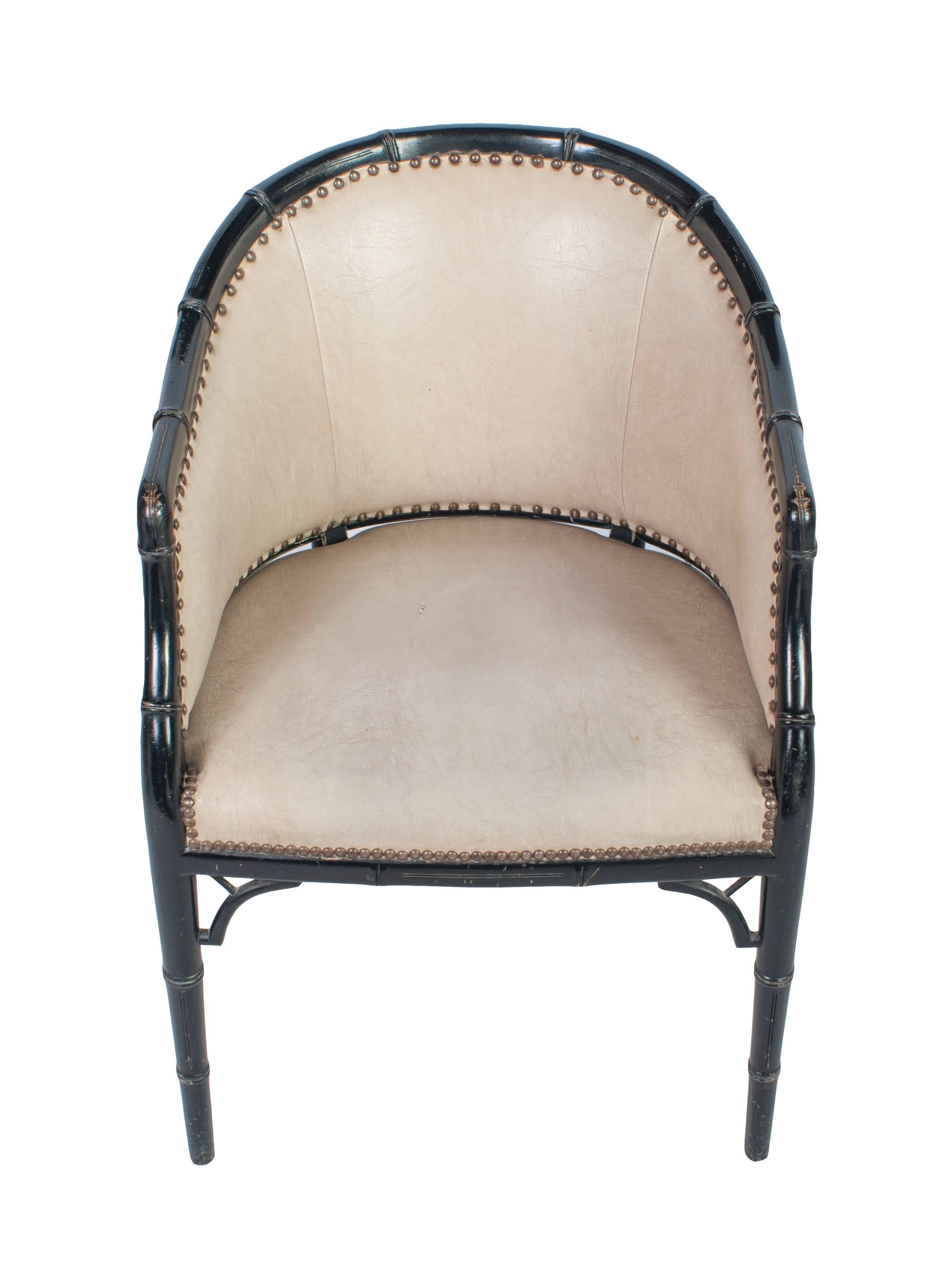 Black painted Bergere chair in a faux bamboo frame and faux leather upholstery.
