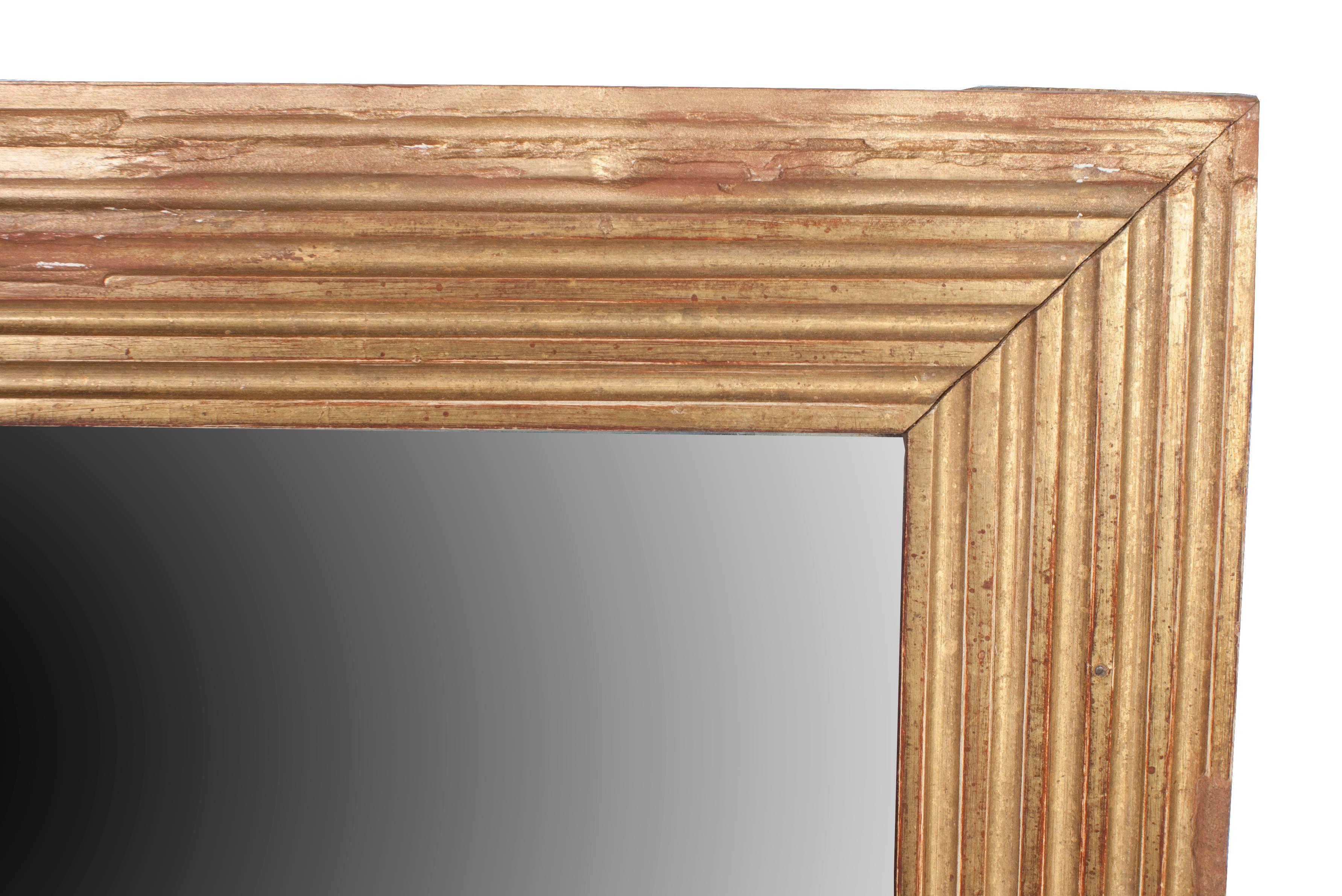 A gilt Louis XVI baguette frame mirror.