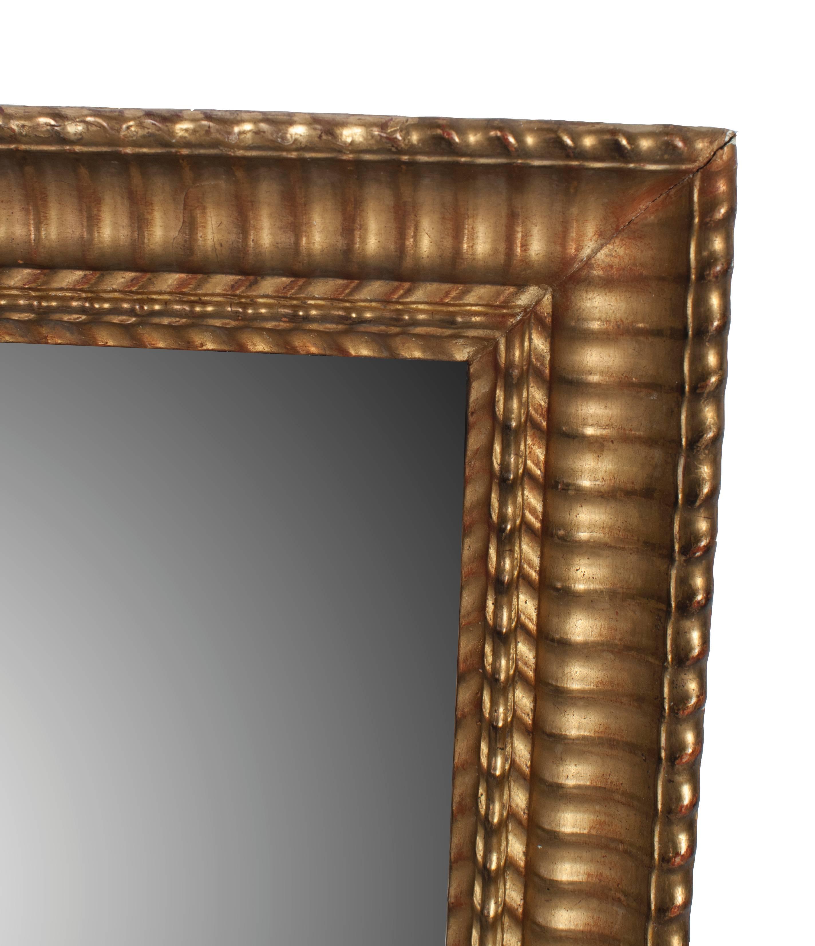 Gilt Napoleon III mirror with small flame stitch pattern trim frame.