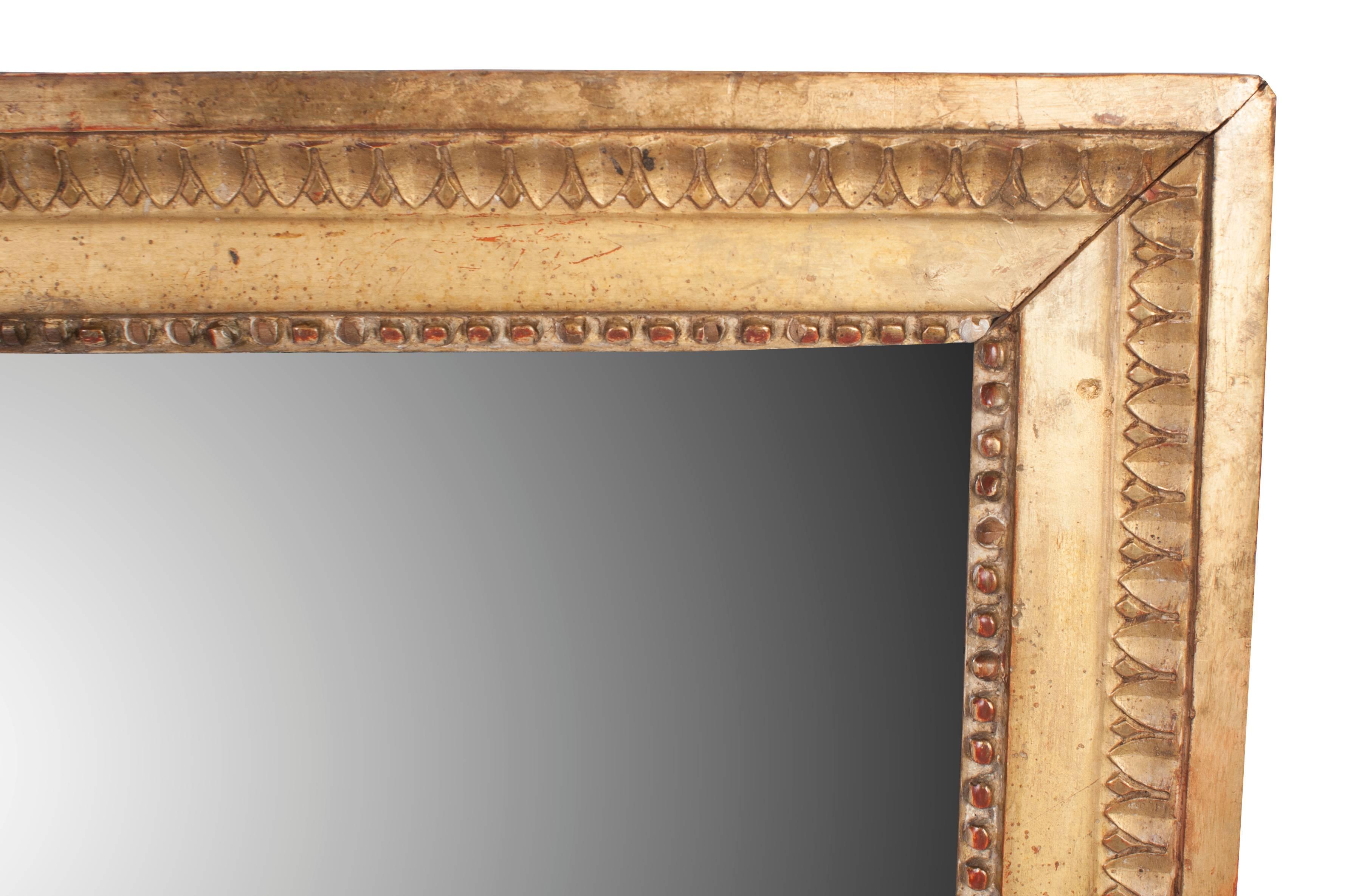 A Louis XVI gilt mirror with original mercury glass.
