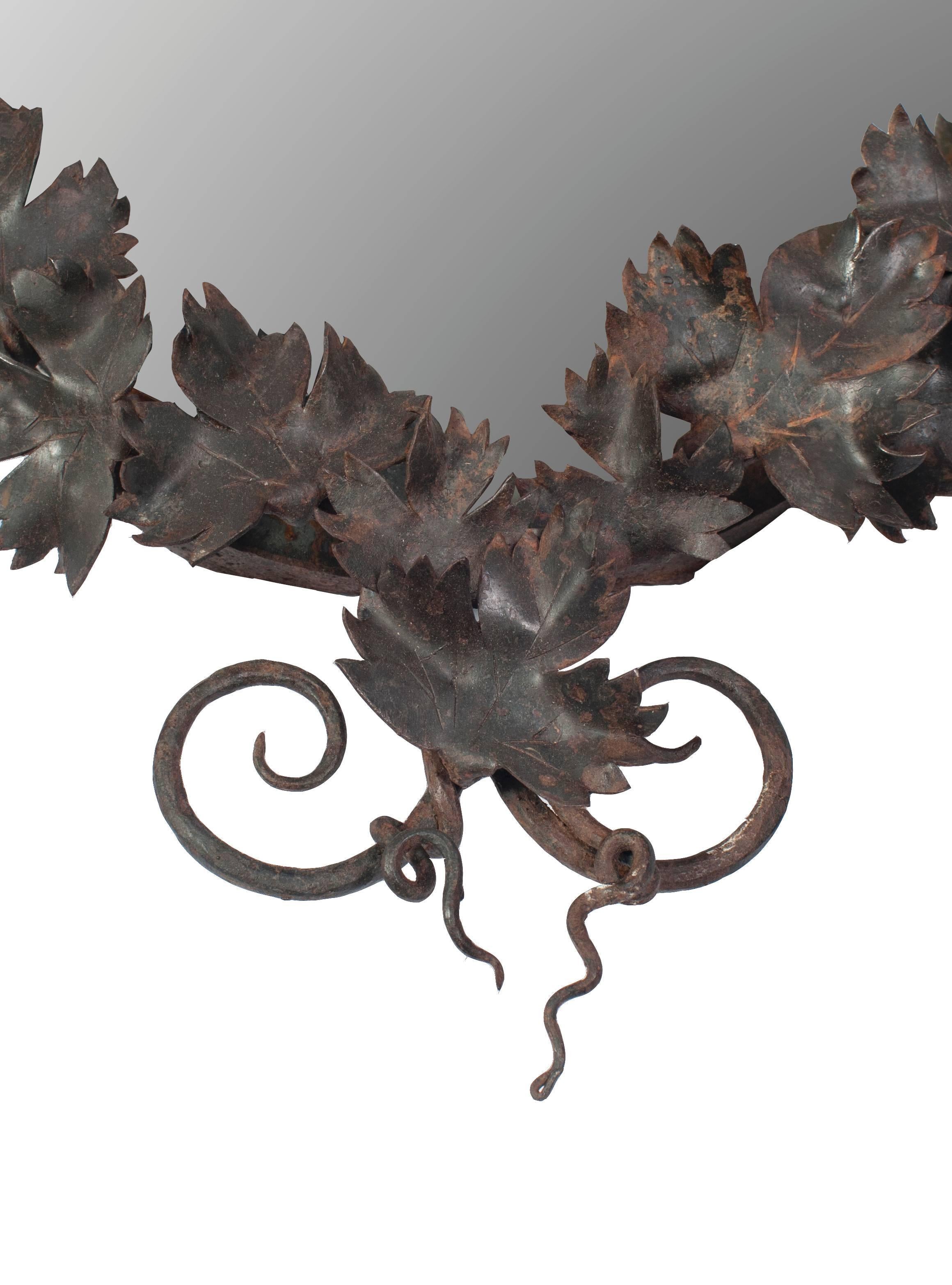 Wrought iron mirror with leaf motif.