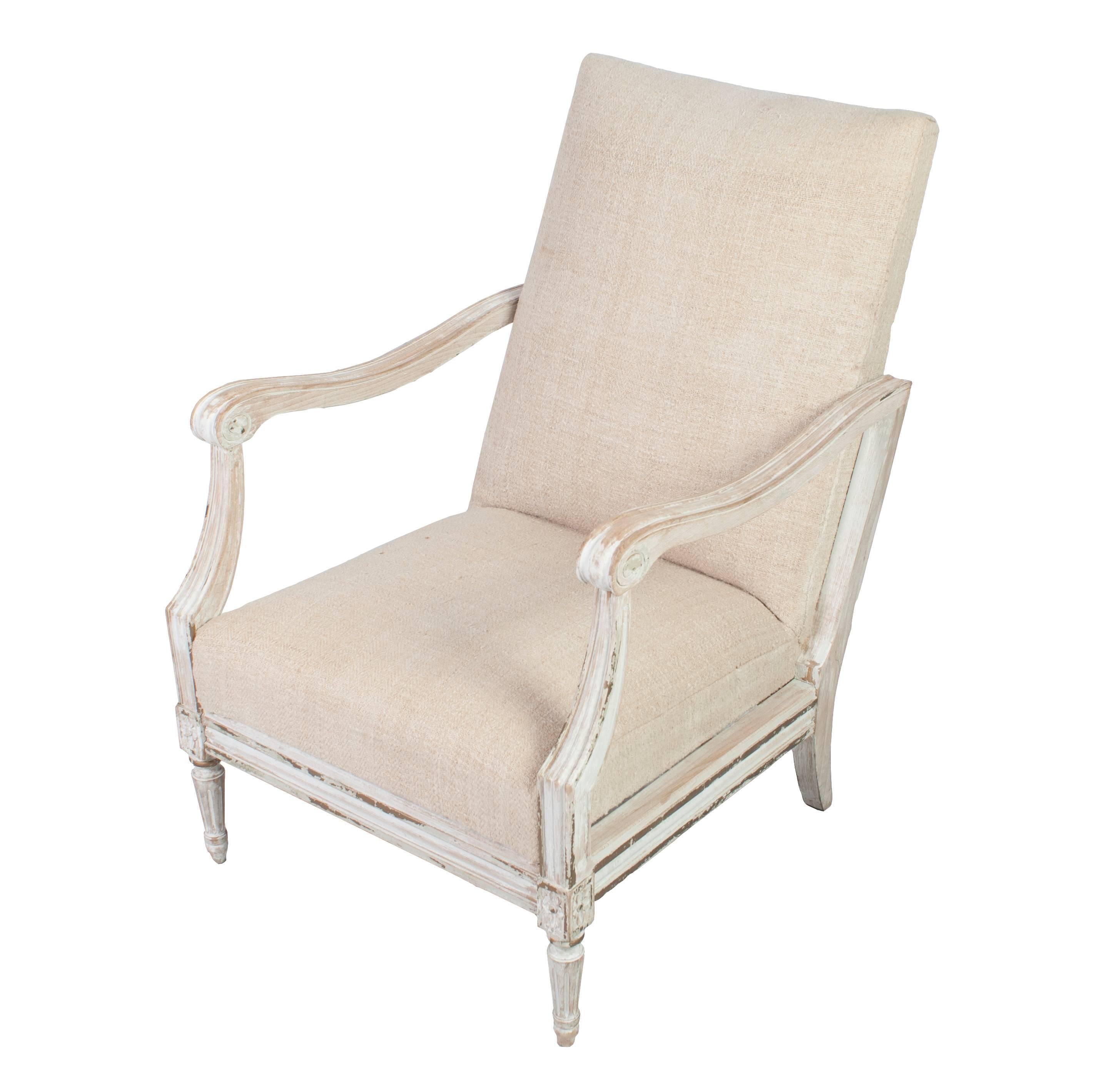 Pair of white painted fauteuils, natural wood frame, covered in antique hemp fabric. Measures: Inside seat depth 19.5 inches. Arm height 23.50 inches.