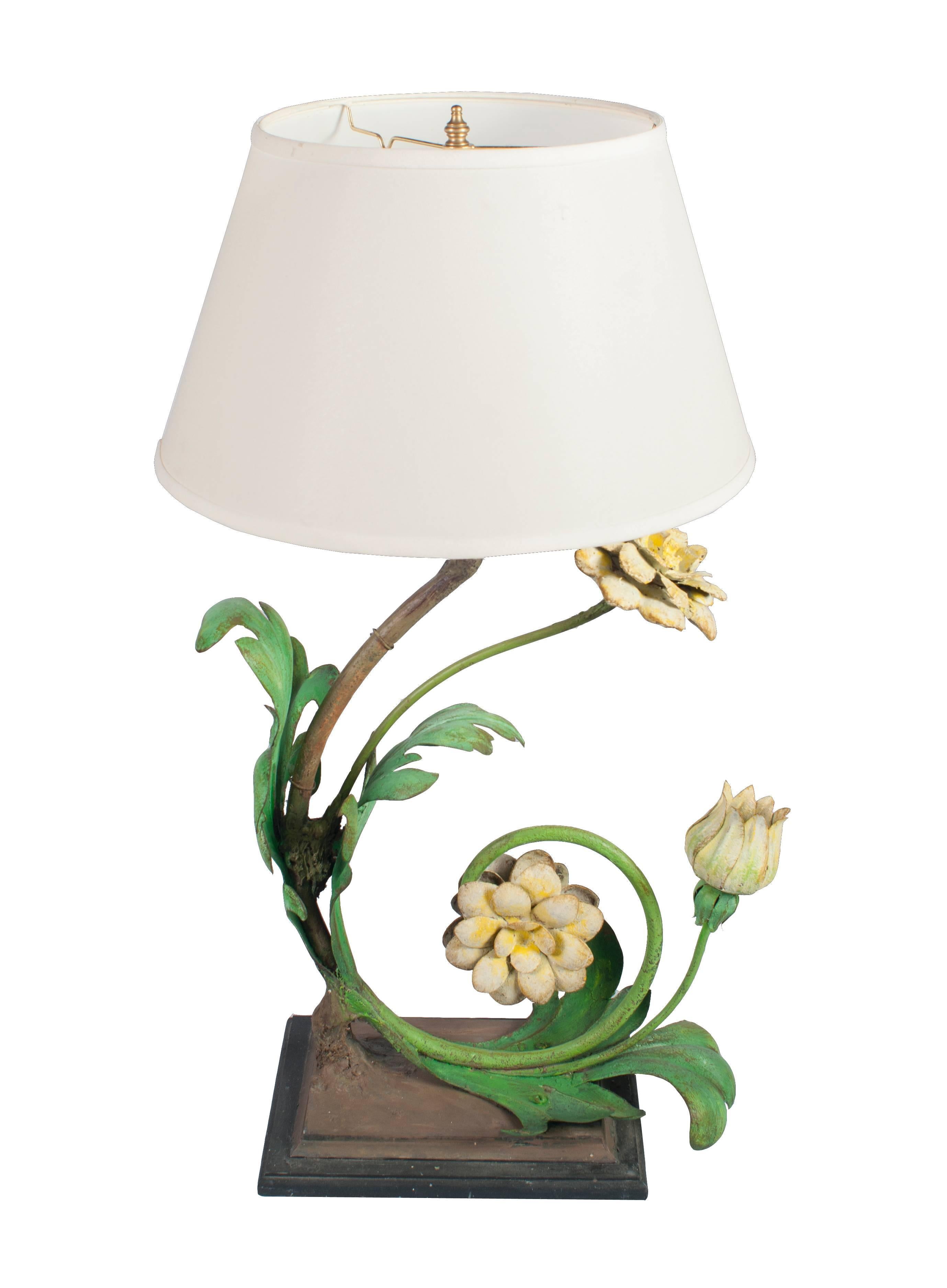 A pair of painted wrought iron table lamps in the form of flowers.

Height is 32