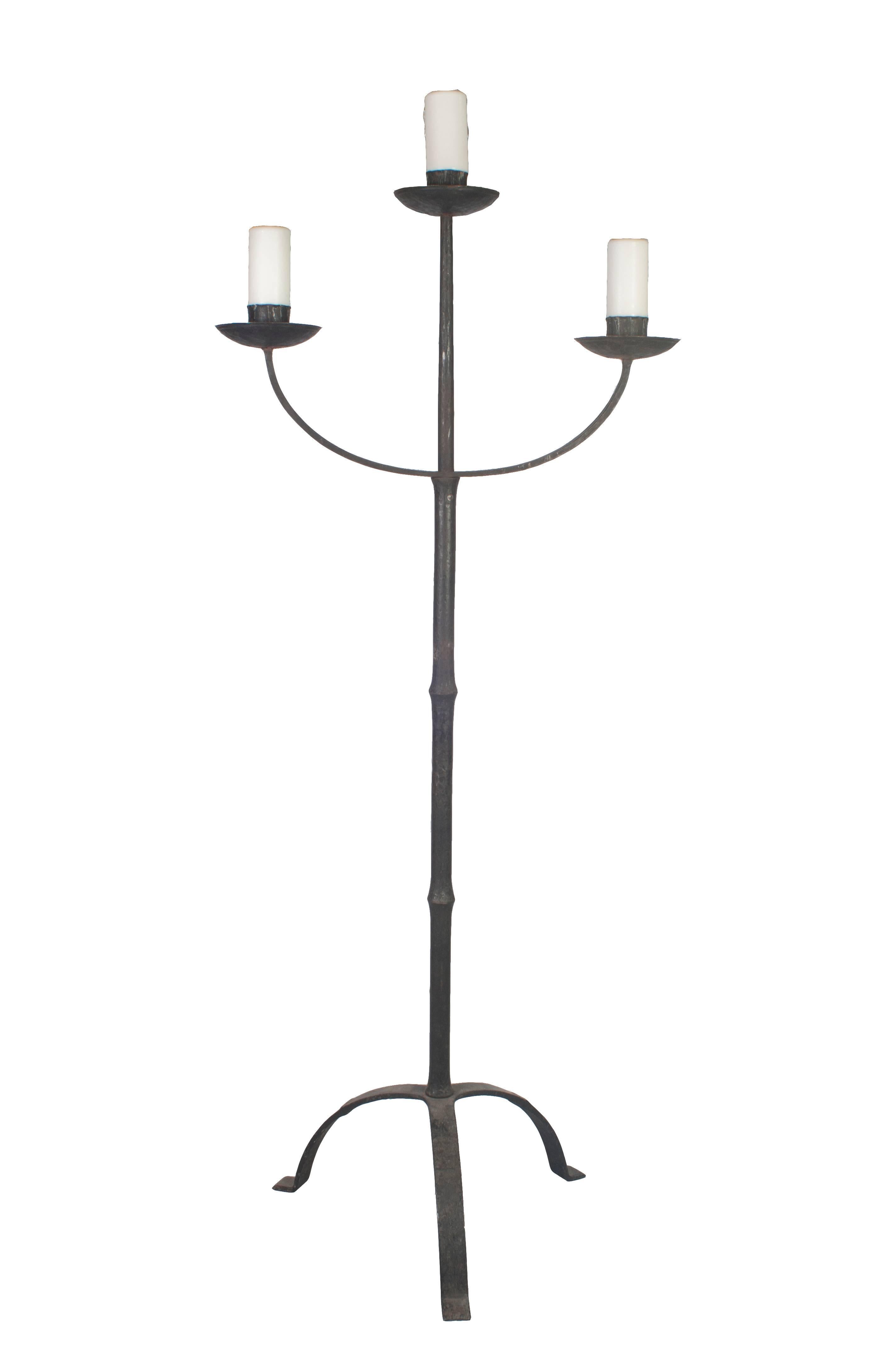 A pair of early Italian cast iron standing floor candelabras with three Arms.