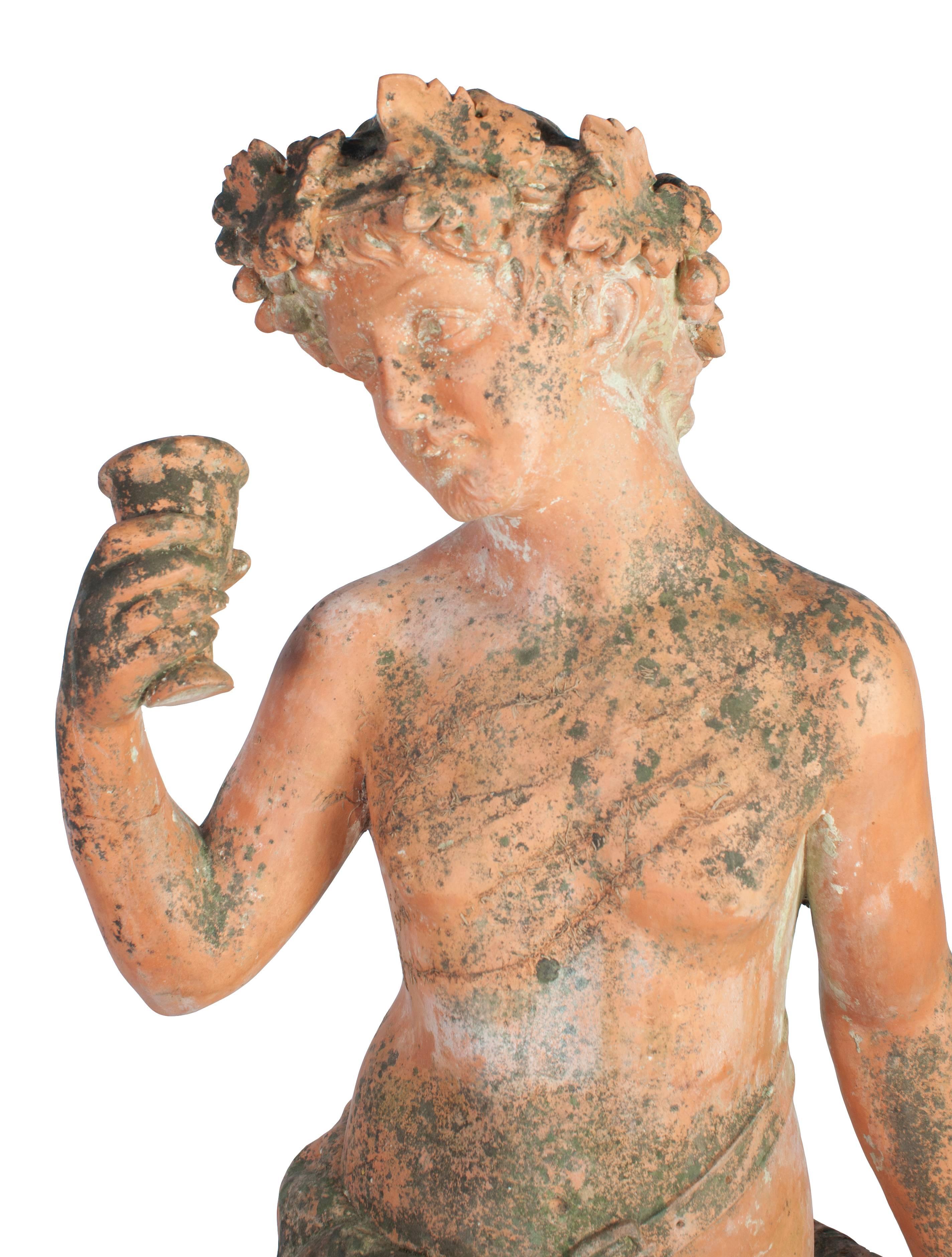 A red terra cotta statue of Bacchus god of wine in two parts.