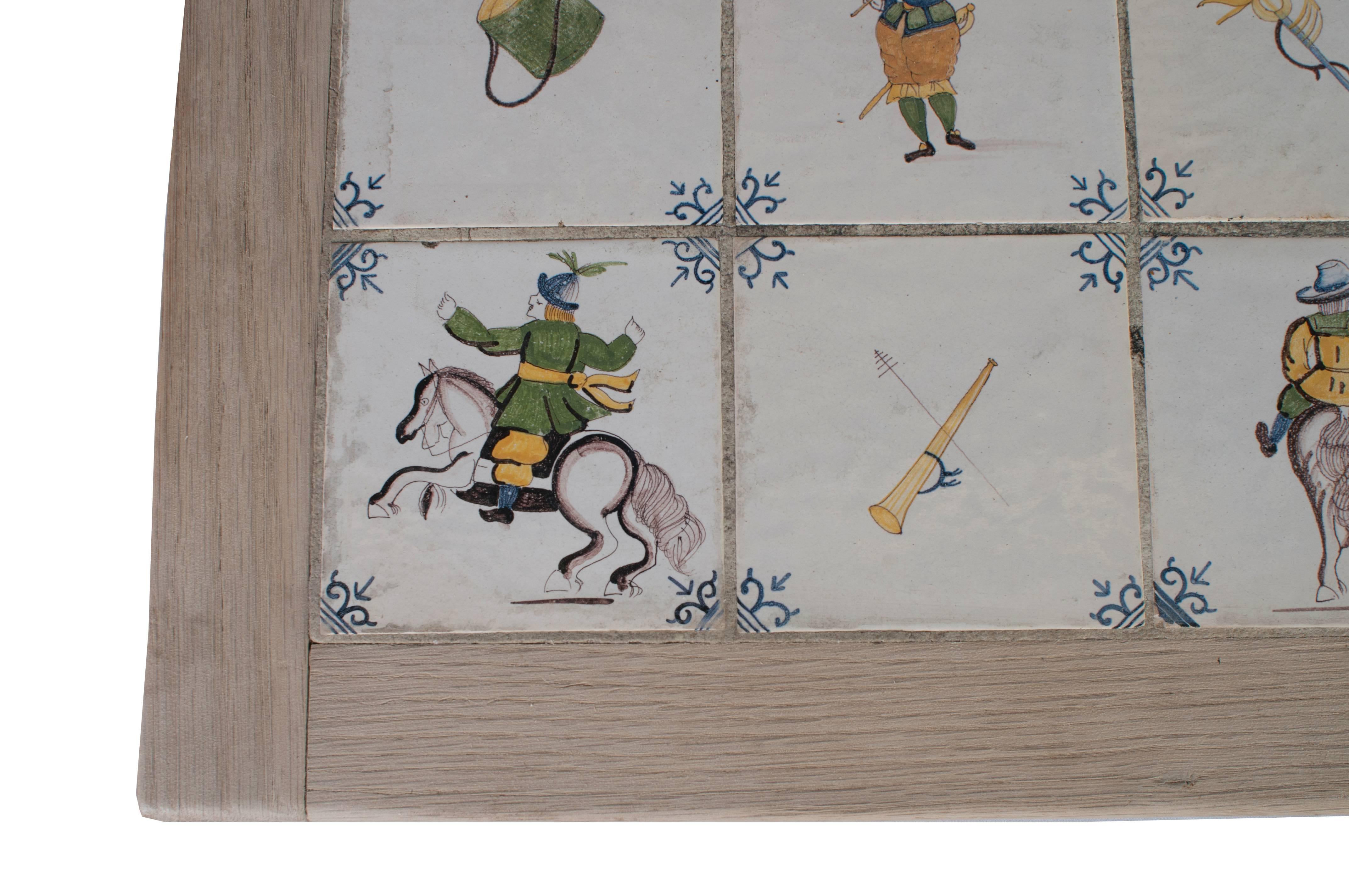 Ten Delft tiles inset in a painted wood frame.