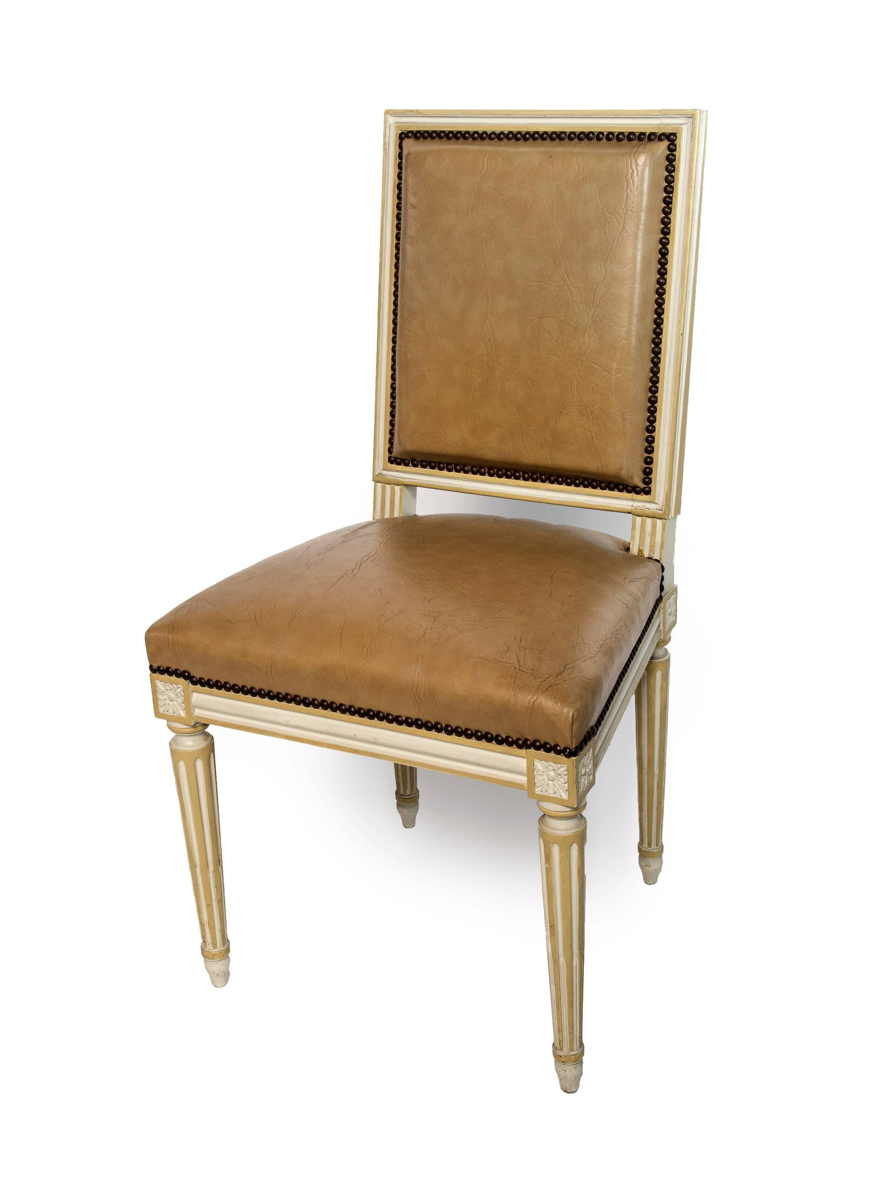 Set of four square back Louis XVI dining chairs covered in a tan leather.