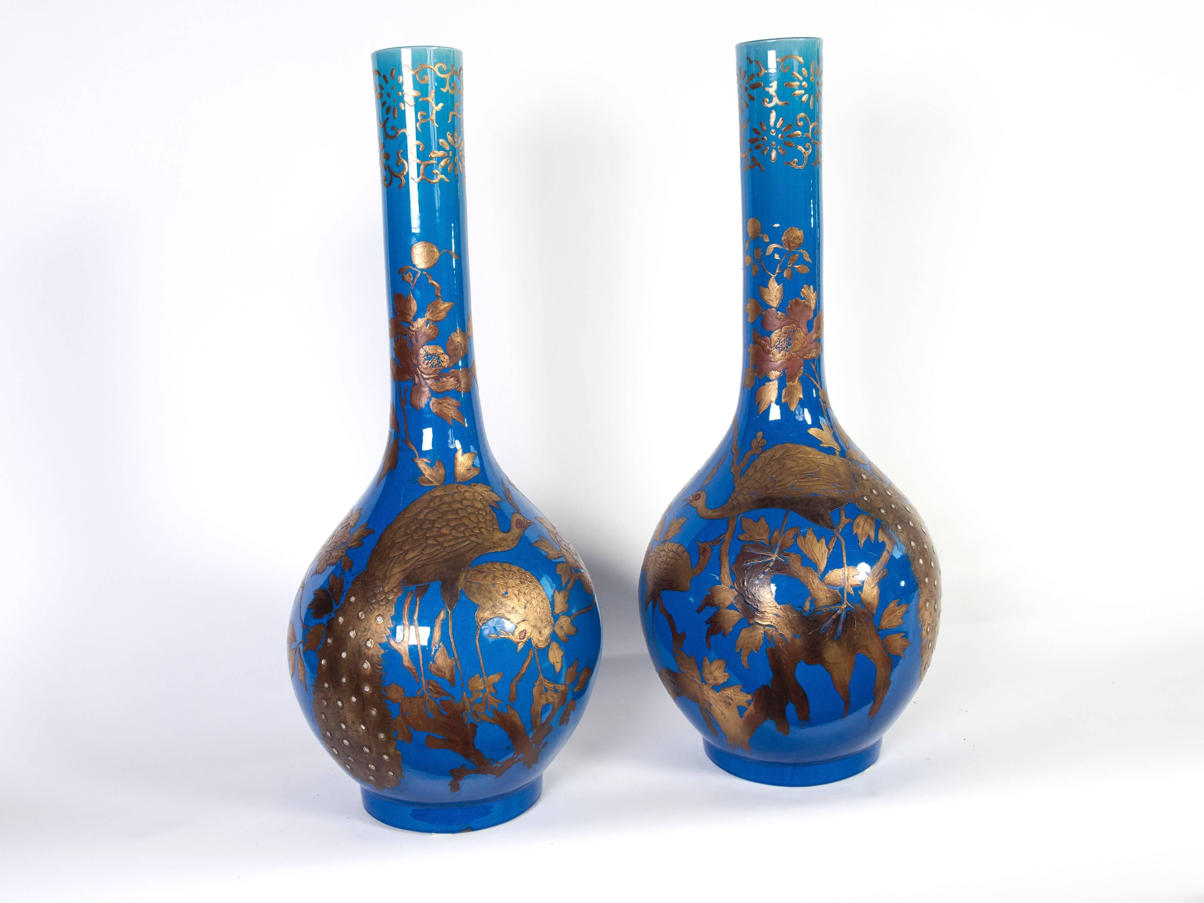 These are an exceptional pair of large blue and gold high glazed ceramic vases.
The detail in gold has really superb quality peacocks surrounded with leaves.
 
  