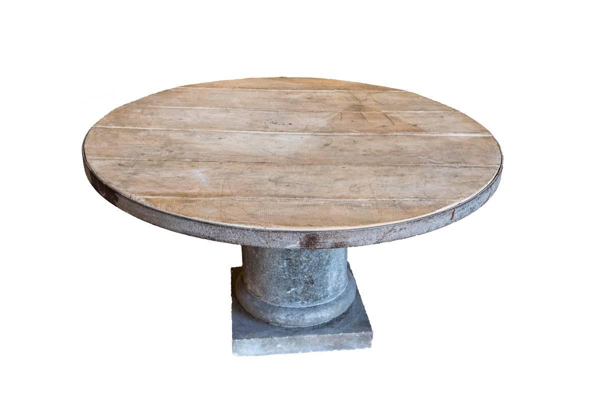 French 19th century limestone table base with a wooden top.