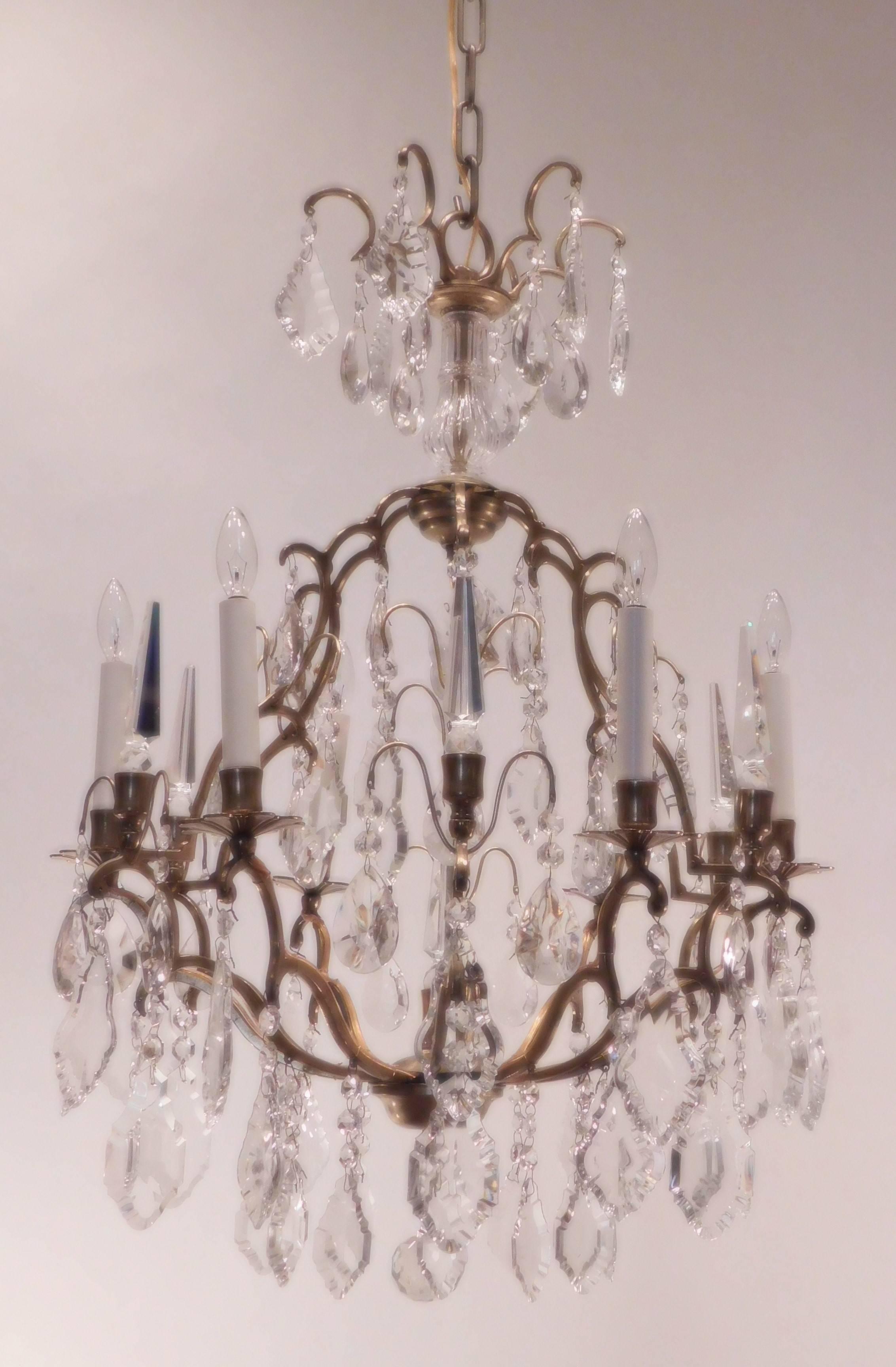 Brass frame with lead crystal spikes, florets and Baccarat cut prisms. Hanging hardware, chain and ceiling cap included.