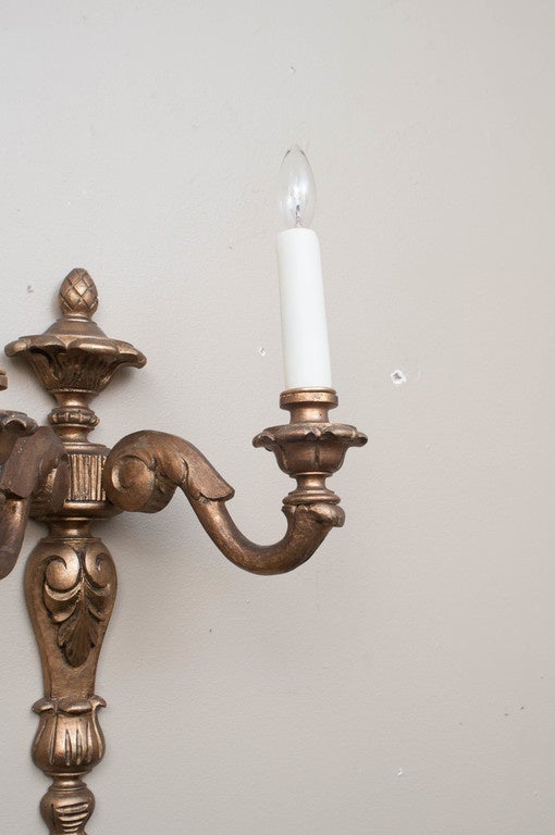 Hand-carved two-light sconces with oil gilt finish - shades not included.