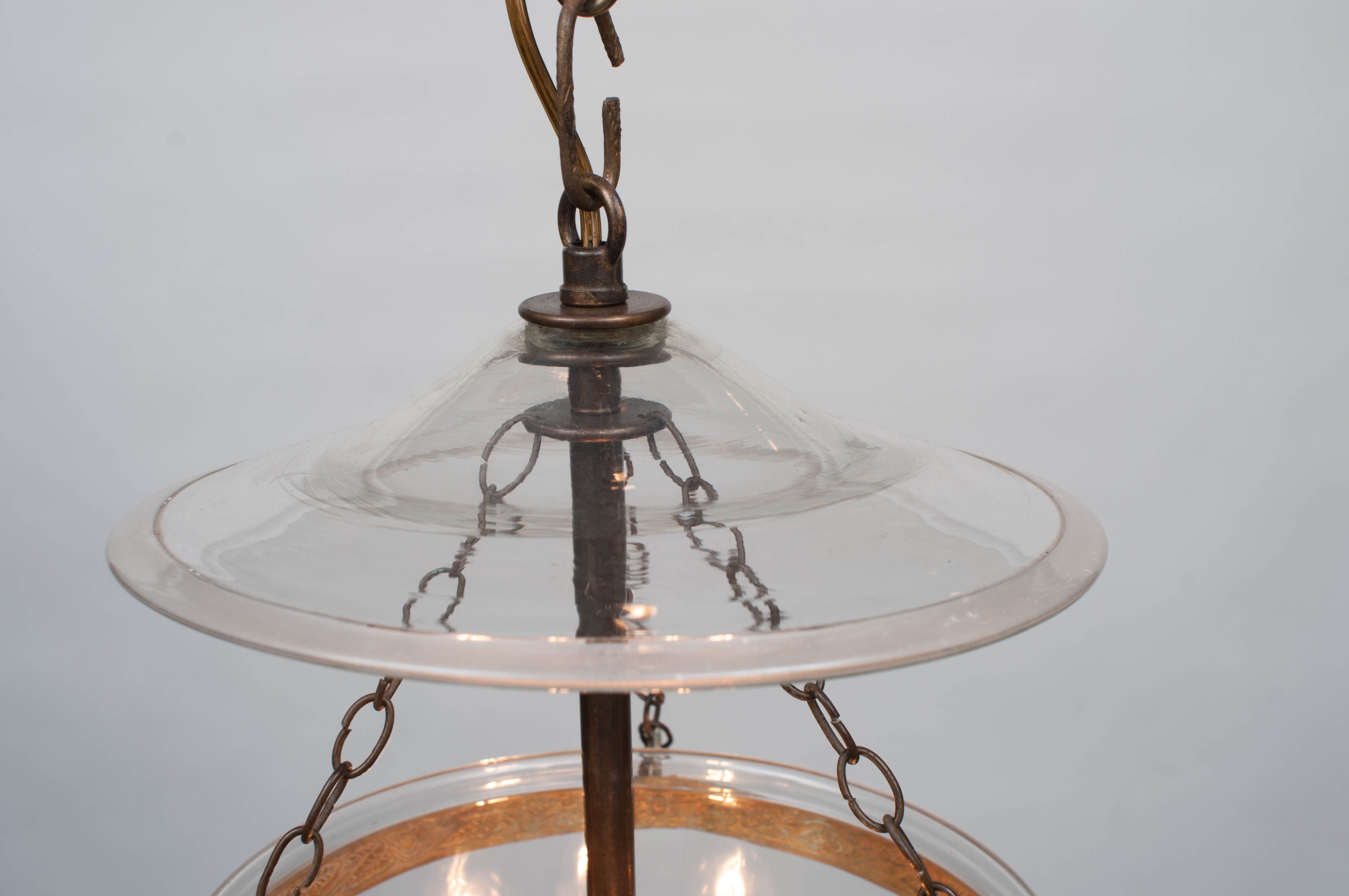 Ormolu mounting - hand blown bell and smoke plate - etched glass in star pattern - aged brass shaft in center with three lights - height may be adjusted - includes hanging hardware and appropriate ceiling cap and chain.