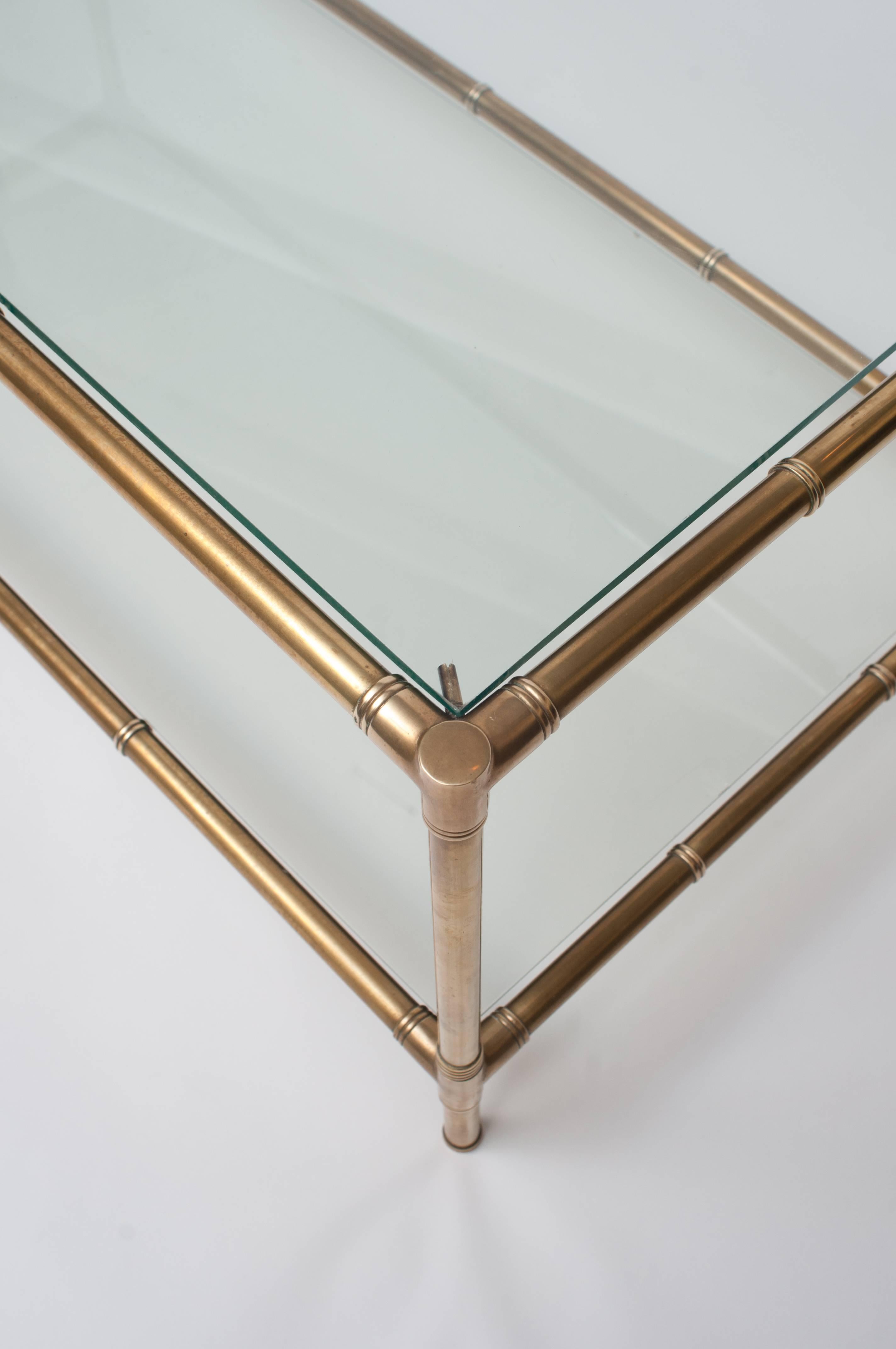 Solid brass two-tier coffee table. The brass parts (legs and sides) have imitation joints emulating bamboo.