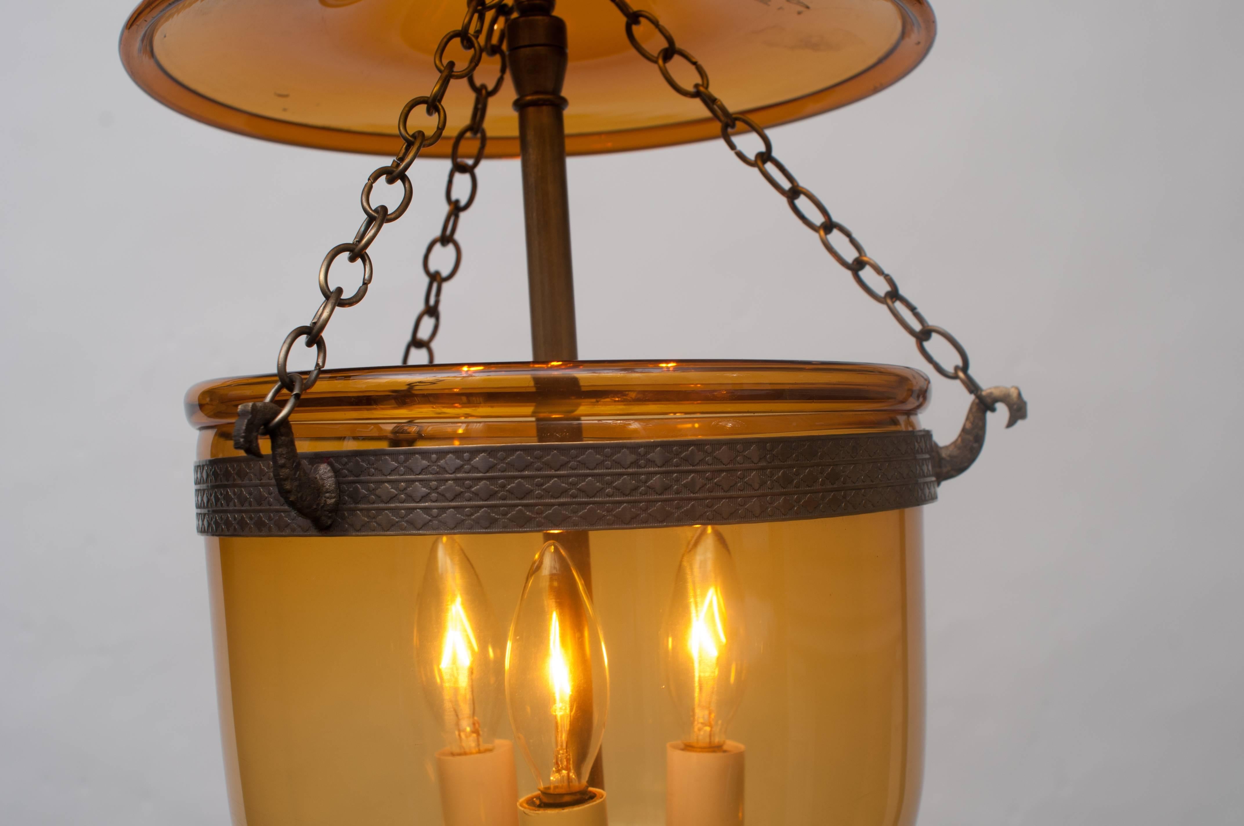 Hand blown glass - plain (no etching) - glass pontil (finial). Original band and smoke bell. Was originally candle or oil-burning, now electrified with new three-light cluster. Height can be adjusted. Ceiling cap, chain, and hanging hardware