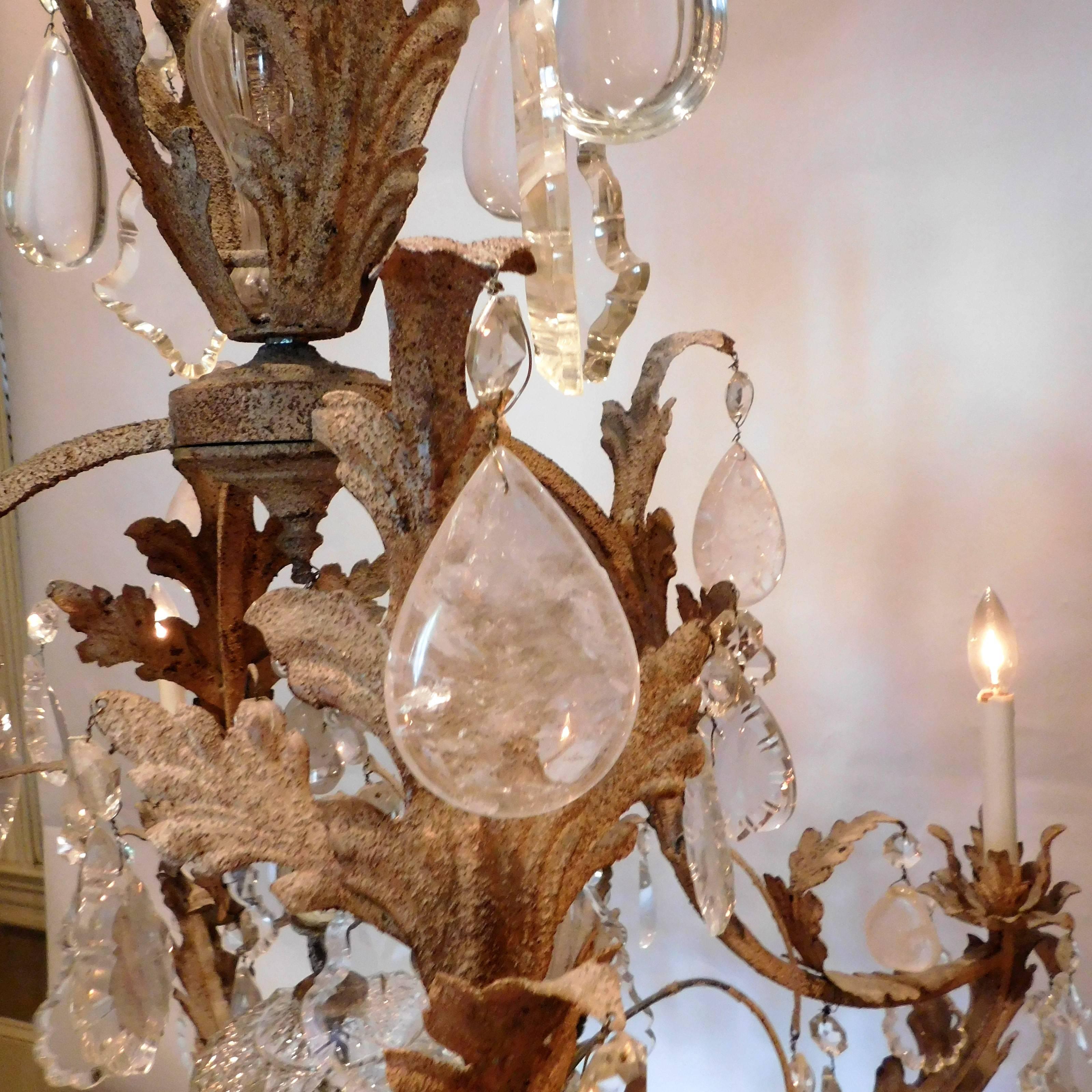 Handcrafted patinated metal frame with hand-cut prisms and beautiful neoclassic crystal urn. Wide variety of prism sizes and shapes in both crystal and rock crystal including clusters of rock crystal grapes. Includes chain, hanging hardware and