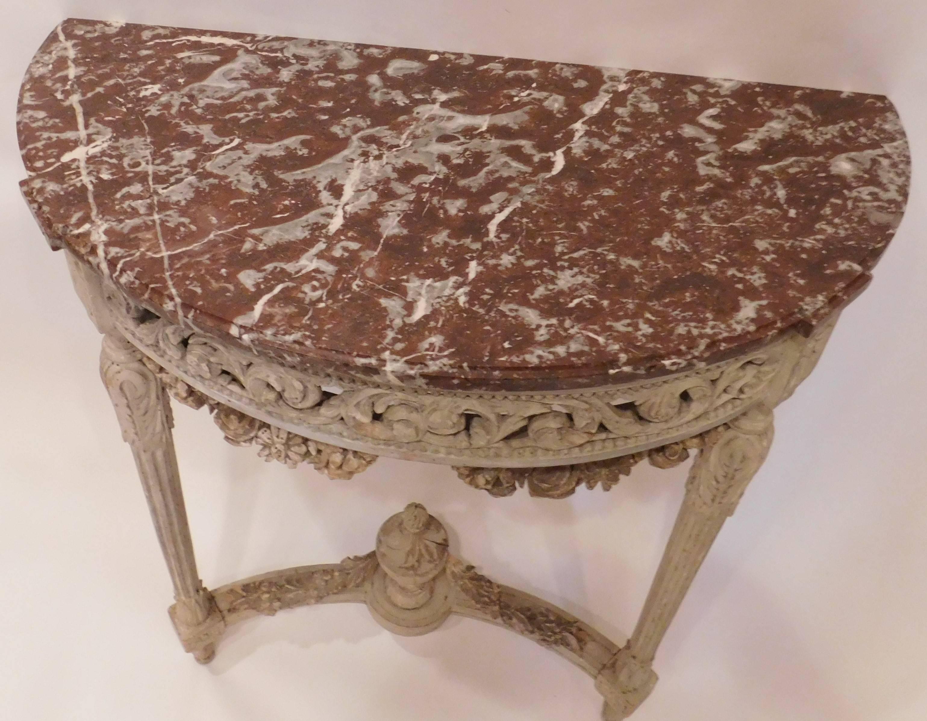 Hand-carved fruitwood with applied ornament beveled edge shaped marble top stretcher with hand-turned urn and applied garland skirt has excellent pierced carving soft grayed white made in either France or Italy wall-mounted with two legs.