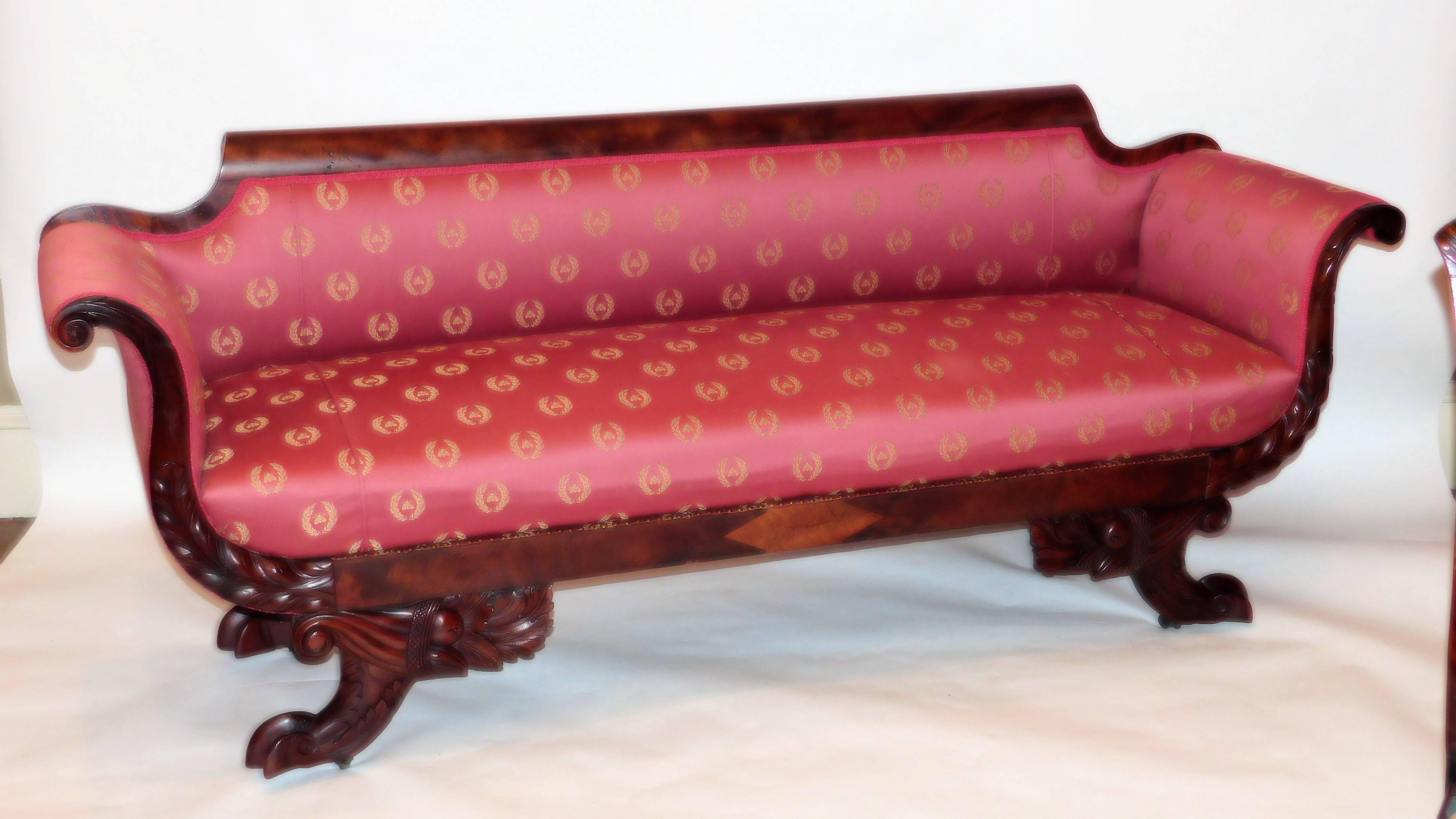 This Empire sofa was probably made either in New England or New York. The frame is mahogany with a maple diamond inlay on the skirt. Excellent carving including acanthus arms and eagle claw feet - superb proportions and size - brass casters.