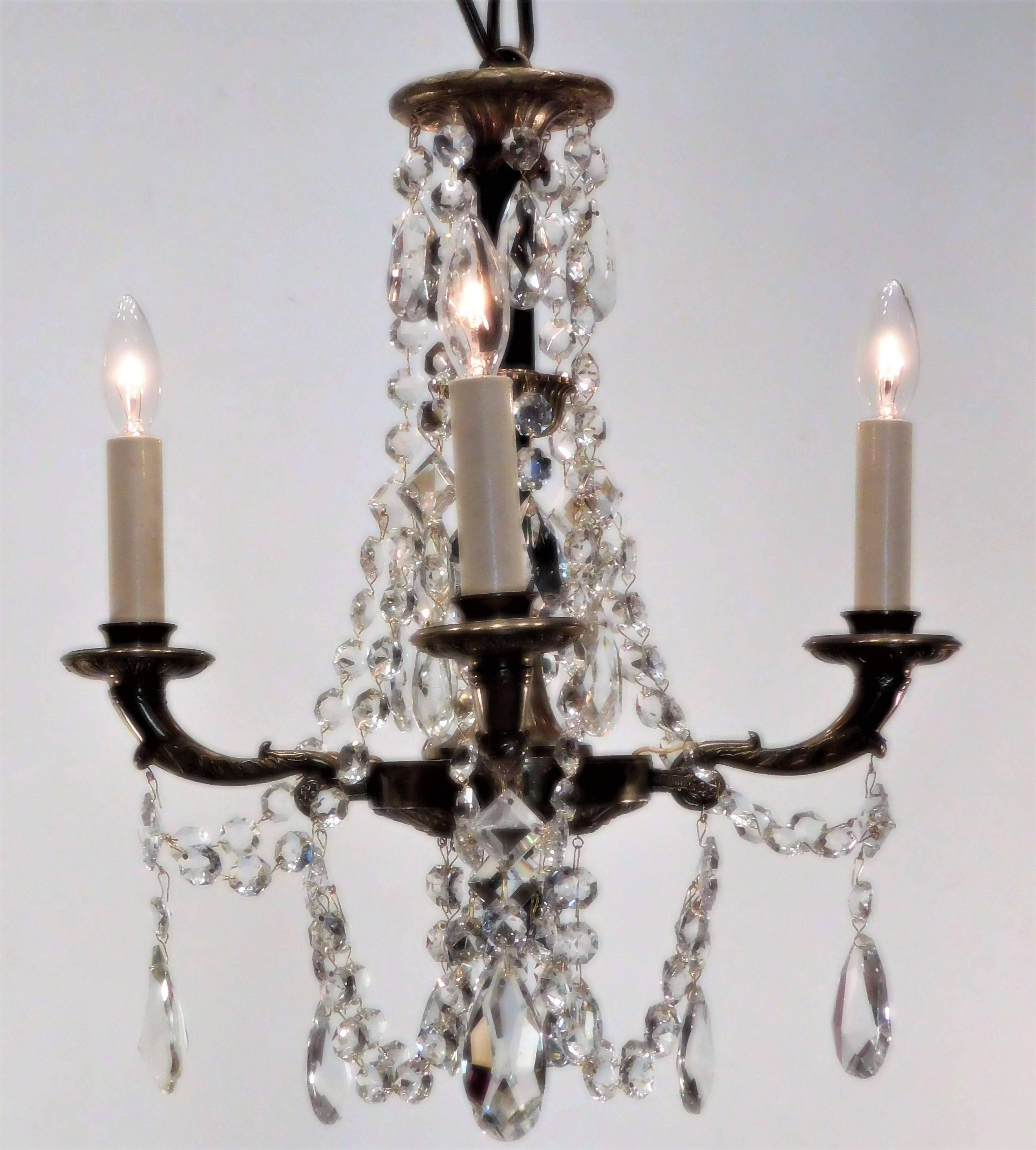 Charming chandelier made of bronze and patinated bronze with Swedish lead crystal prisms ceiling CAP, hanging hardware and up to 1' of chain included.