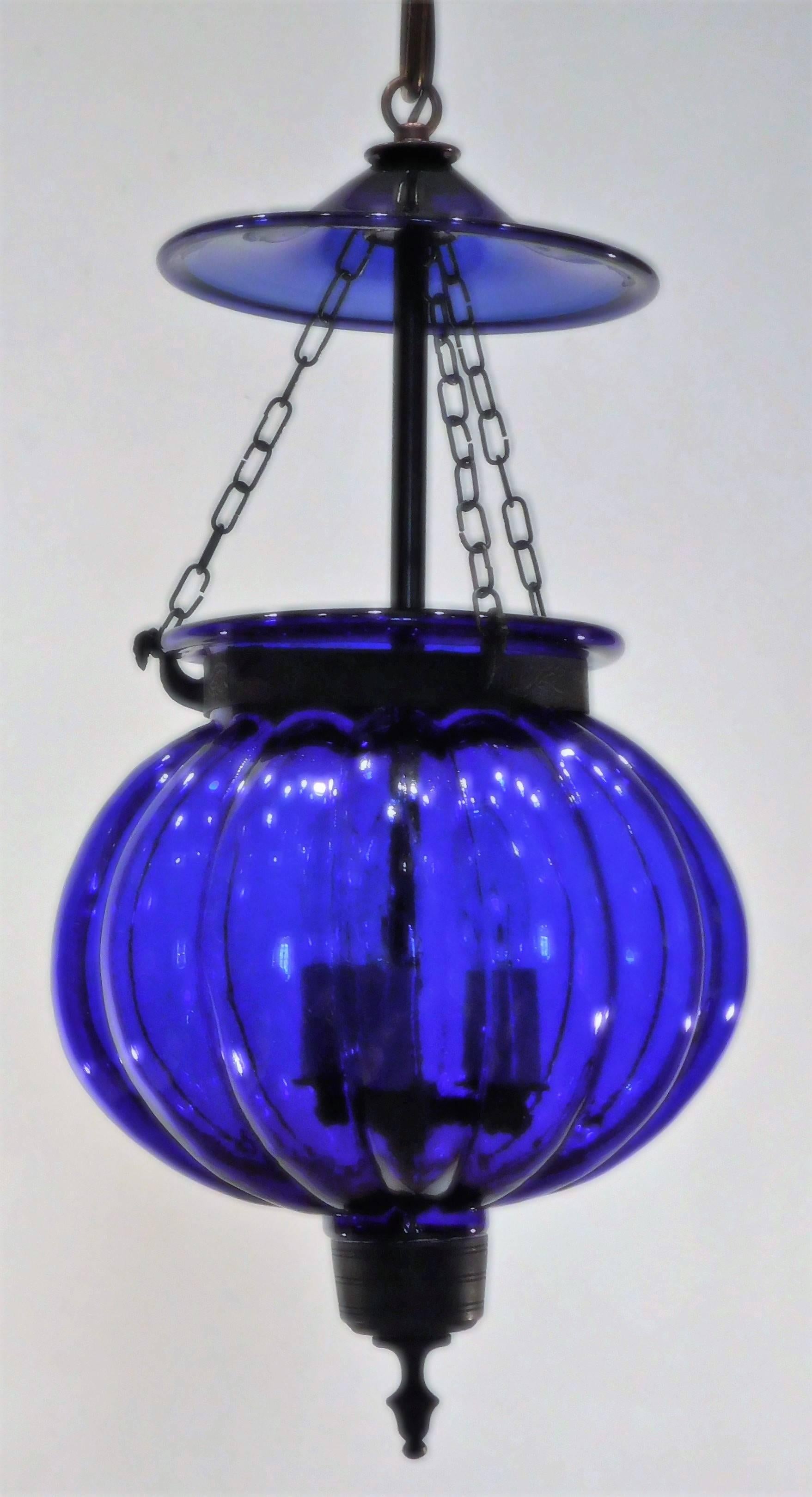 Originally candle-burning, now electrified. Lantern has its original brass fittings wired with three lights. We have another one that matches this one in stock height can be adjusted ceiling CAP, hanging hardware and up to 1' of chain included.