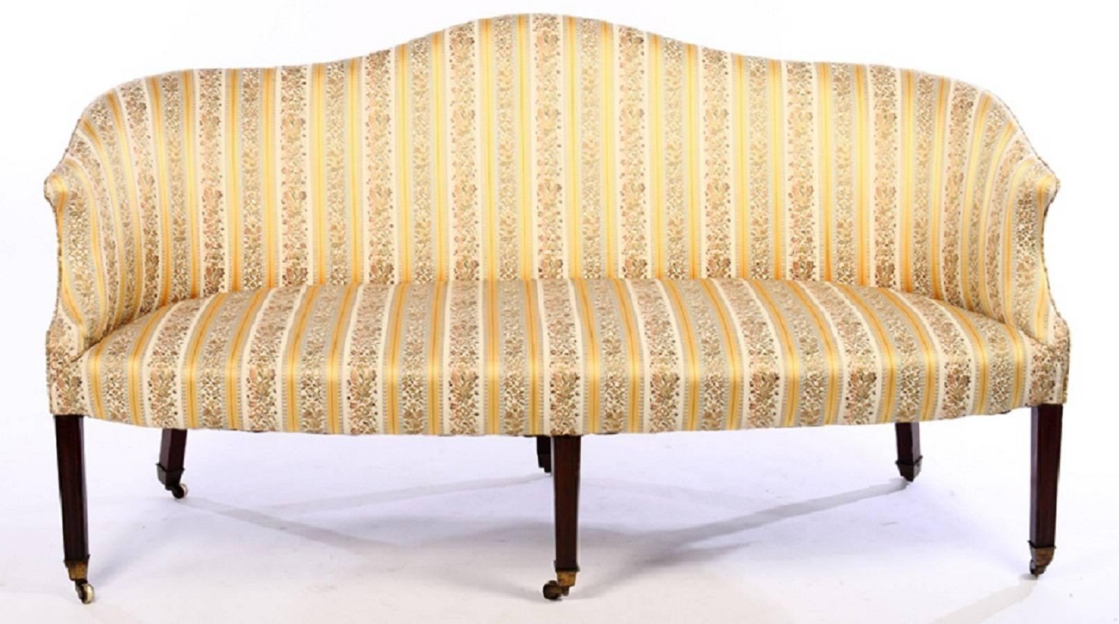 Hepplewhite design. Handsome and graceful sofa with mahogany moulded legs and original castors. Upholstery in great condition, ready for new fabric if desired.