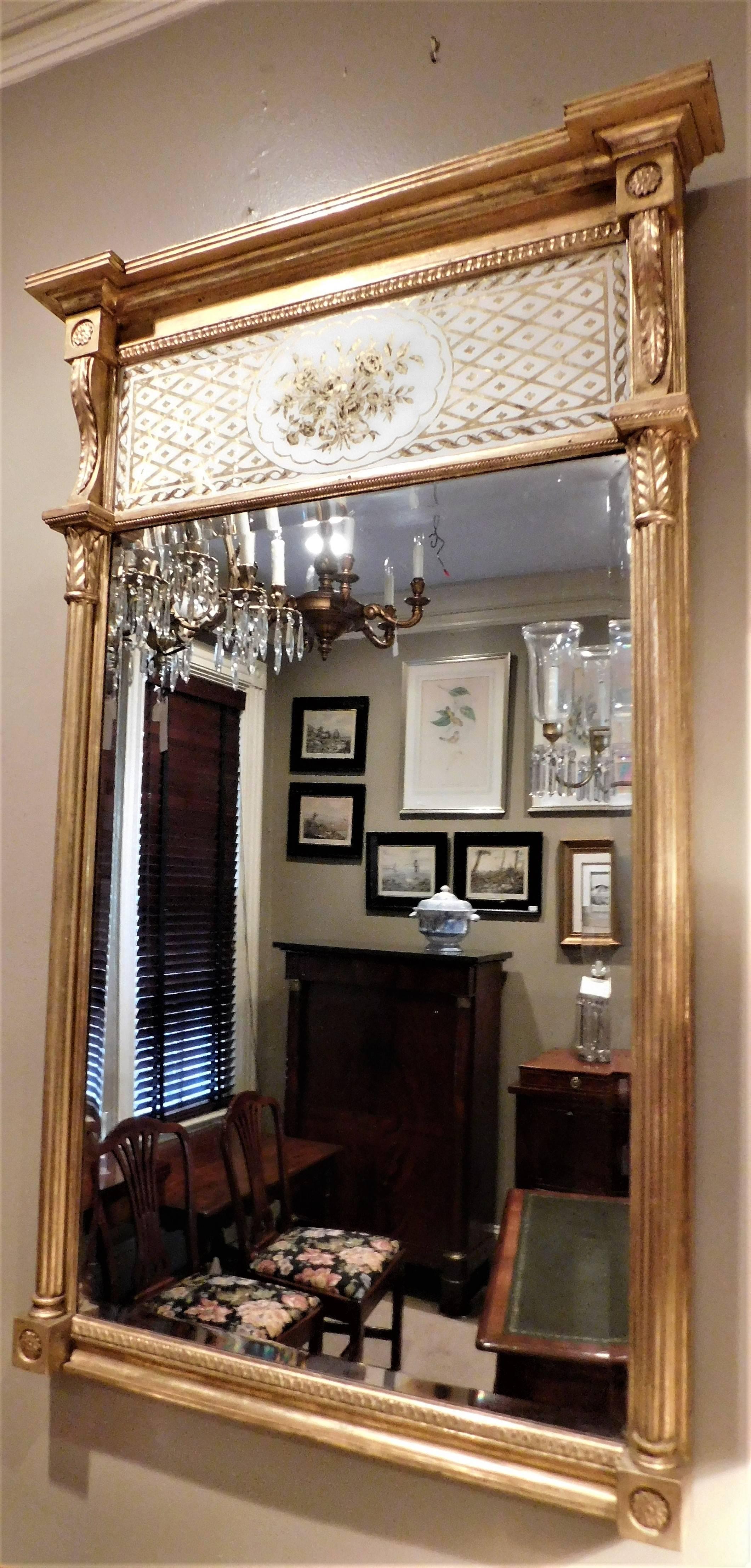 The frame is gold leaf with excellent carving and was probably made in New England or New York. The églomisé panel appears to be original.