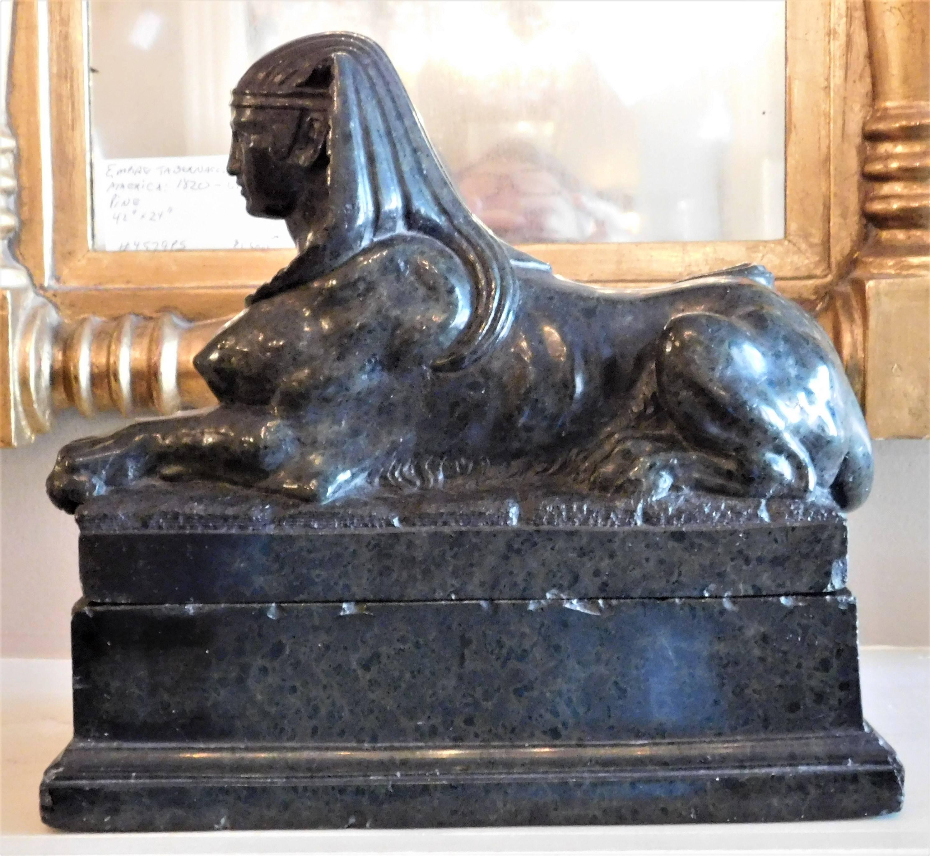 This female sphinx sits on a plinth and was probably carved in Italy. While the marble is a dark olive green and is highly polished, in order to show the detail better we have made some photos lighter in color. The carving is very fine.