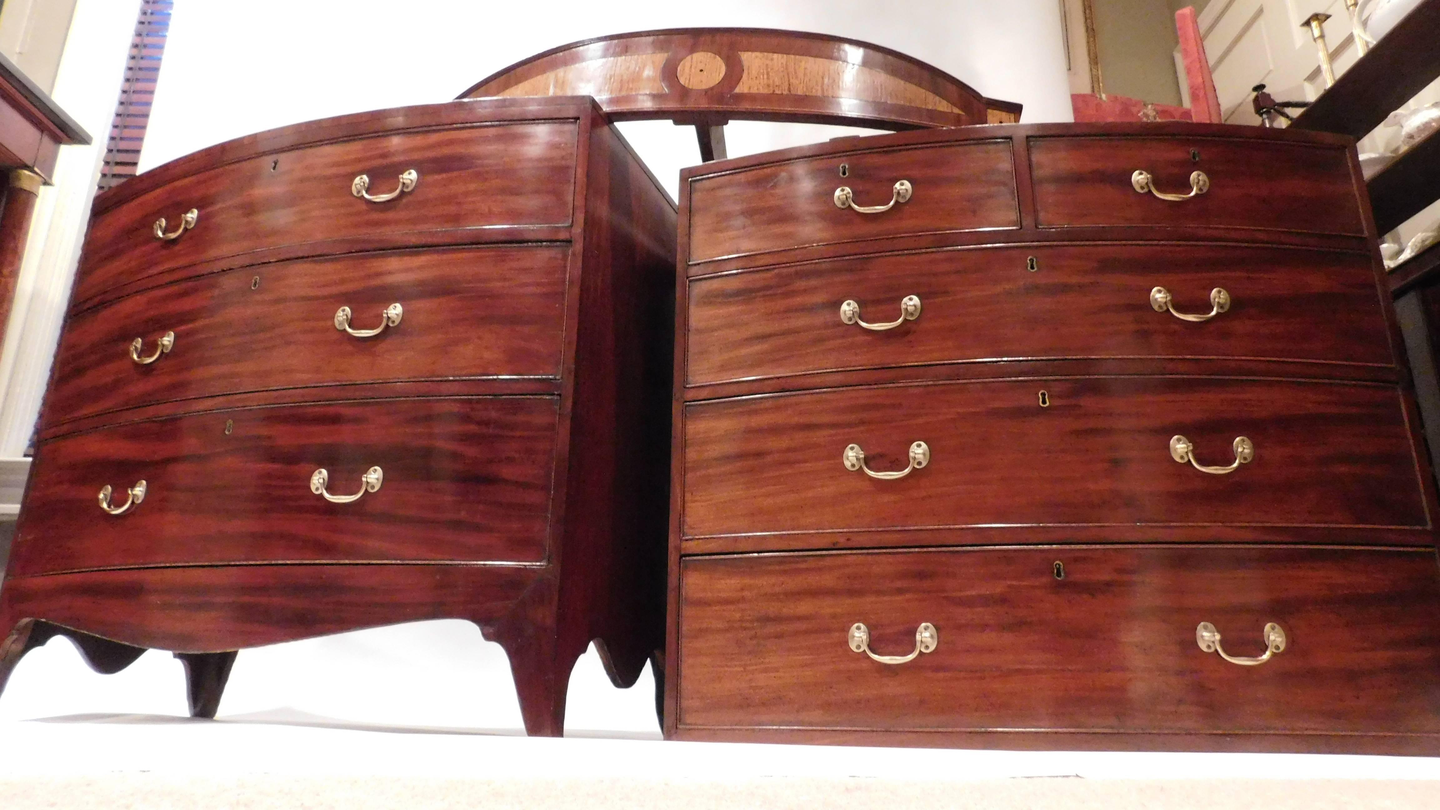 The chest-on-chest is flame mahogany with satinwood and ebony inlay and oak secondary wood. Solid brass old replaced hardware. Hepplewhite design. Two small drawers over six larger graduated drawers. Comes into three pieces for ease of moving.