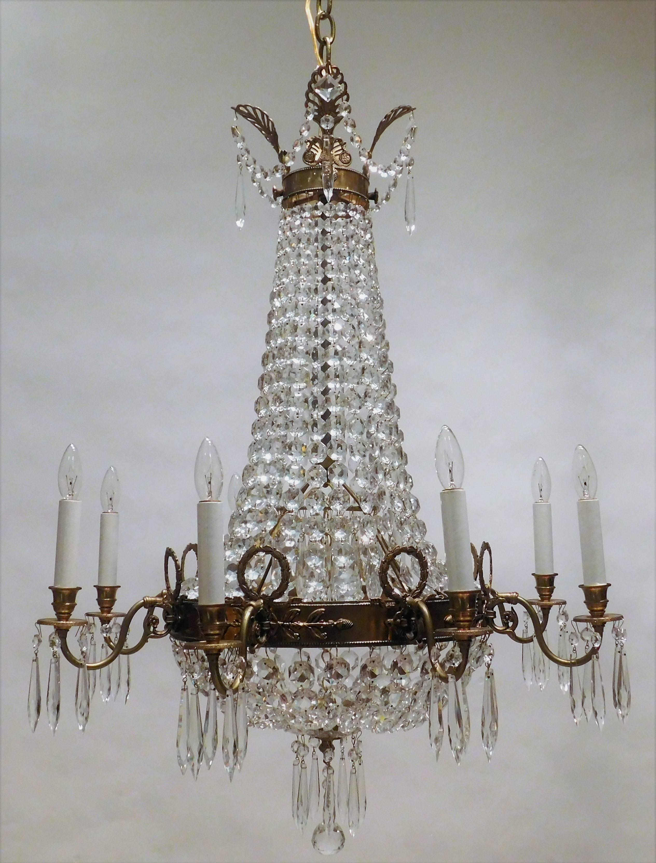 This chandelier was handmade of cast gilt brass with lead crystal. Tent and cascade design, bell shaped. Finely wrought laurel wreaths and acanthus leaf details. Ceiling cap, 1 foot of chain and hanging hardware included.