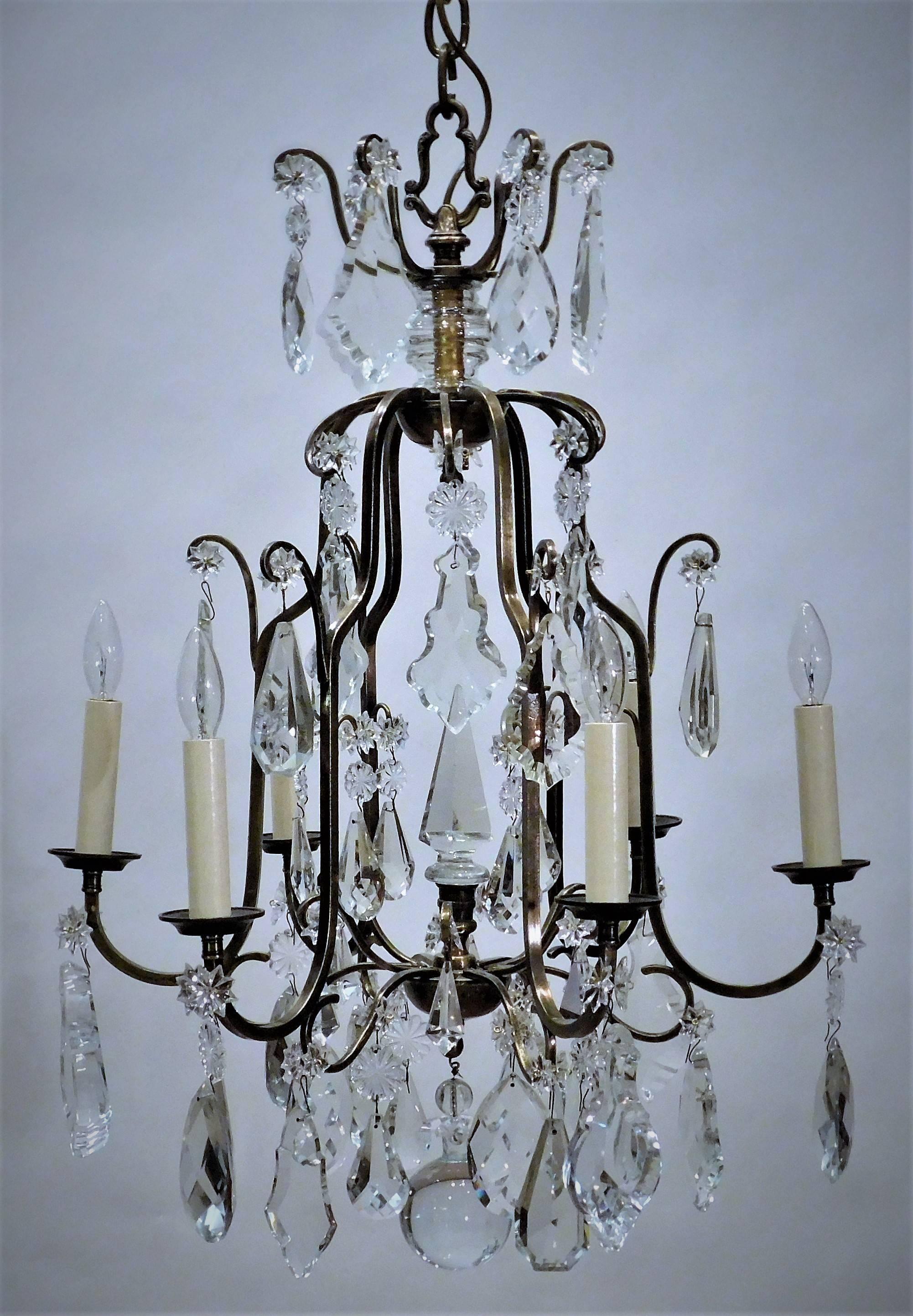 This country Louis XV style chandelier has a lead crystal spike in the middle of the unusual cage form frame. The prisms are French hand cut lead crystal. Ceiling cap, hanging hardware, and one foot of chain included.