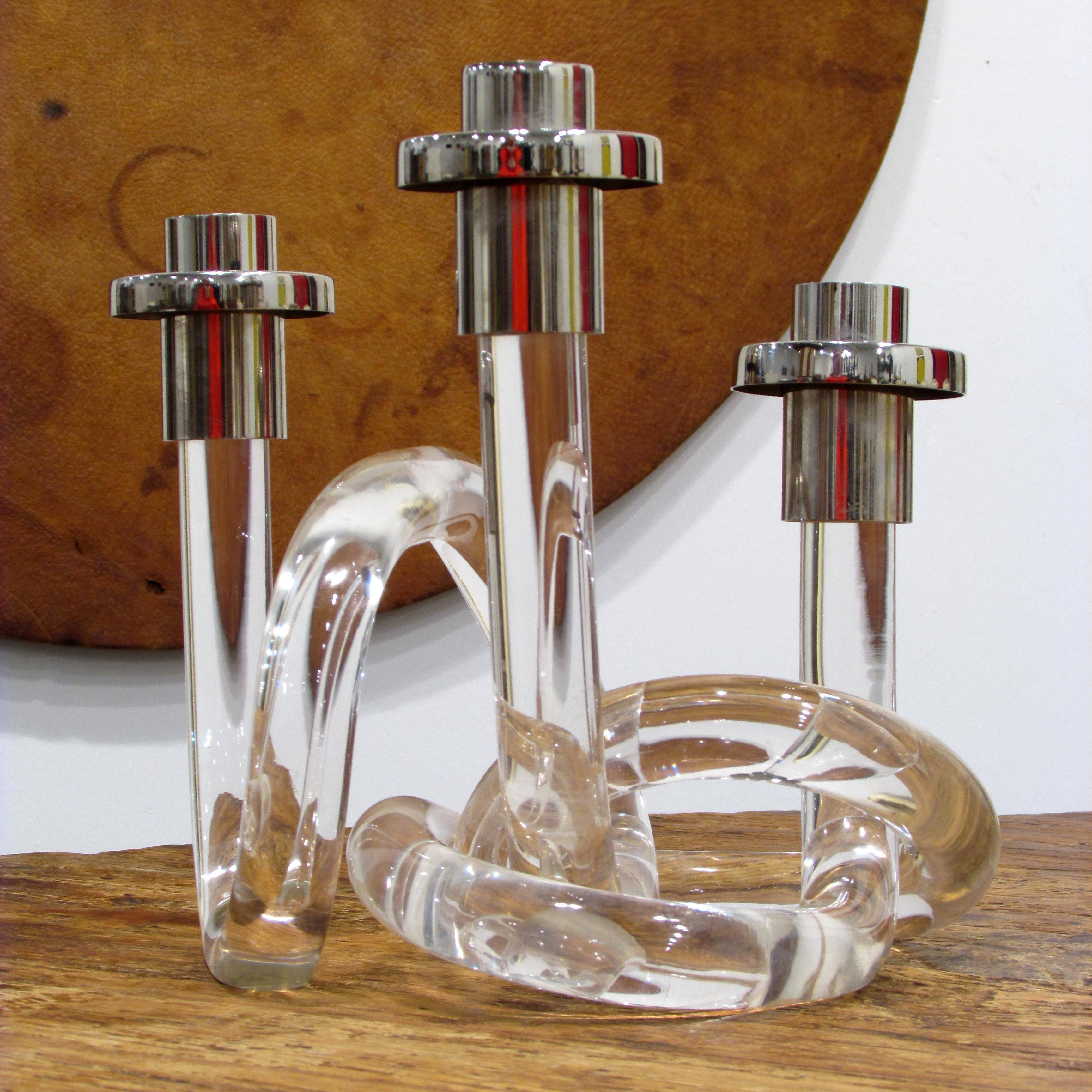 Intriguing two pieces of interlocking Lucite with three nickel-plated candleholders.