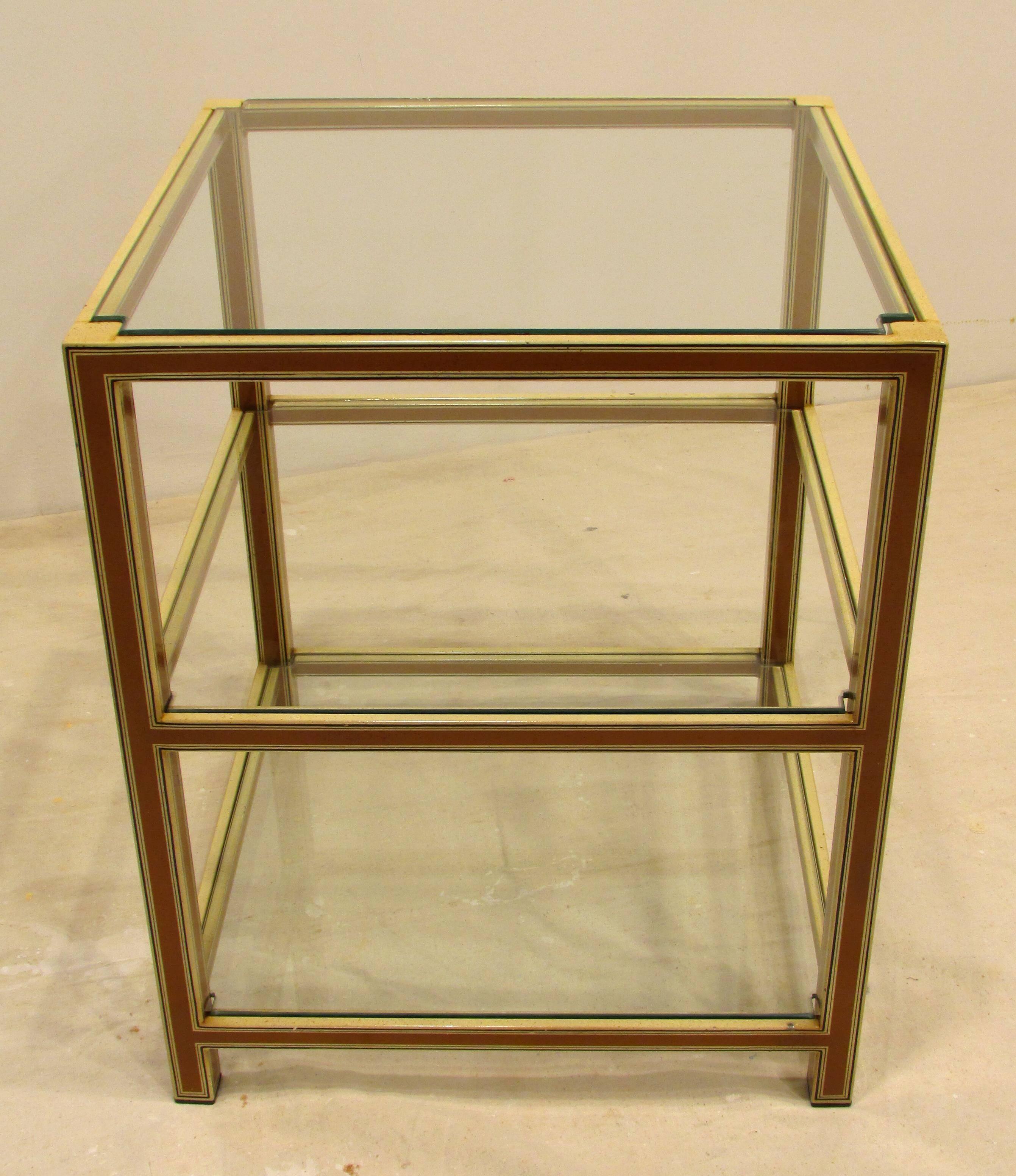 Small side table with hard baked vitreous enamel finish to metal with three inset glass shelves.