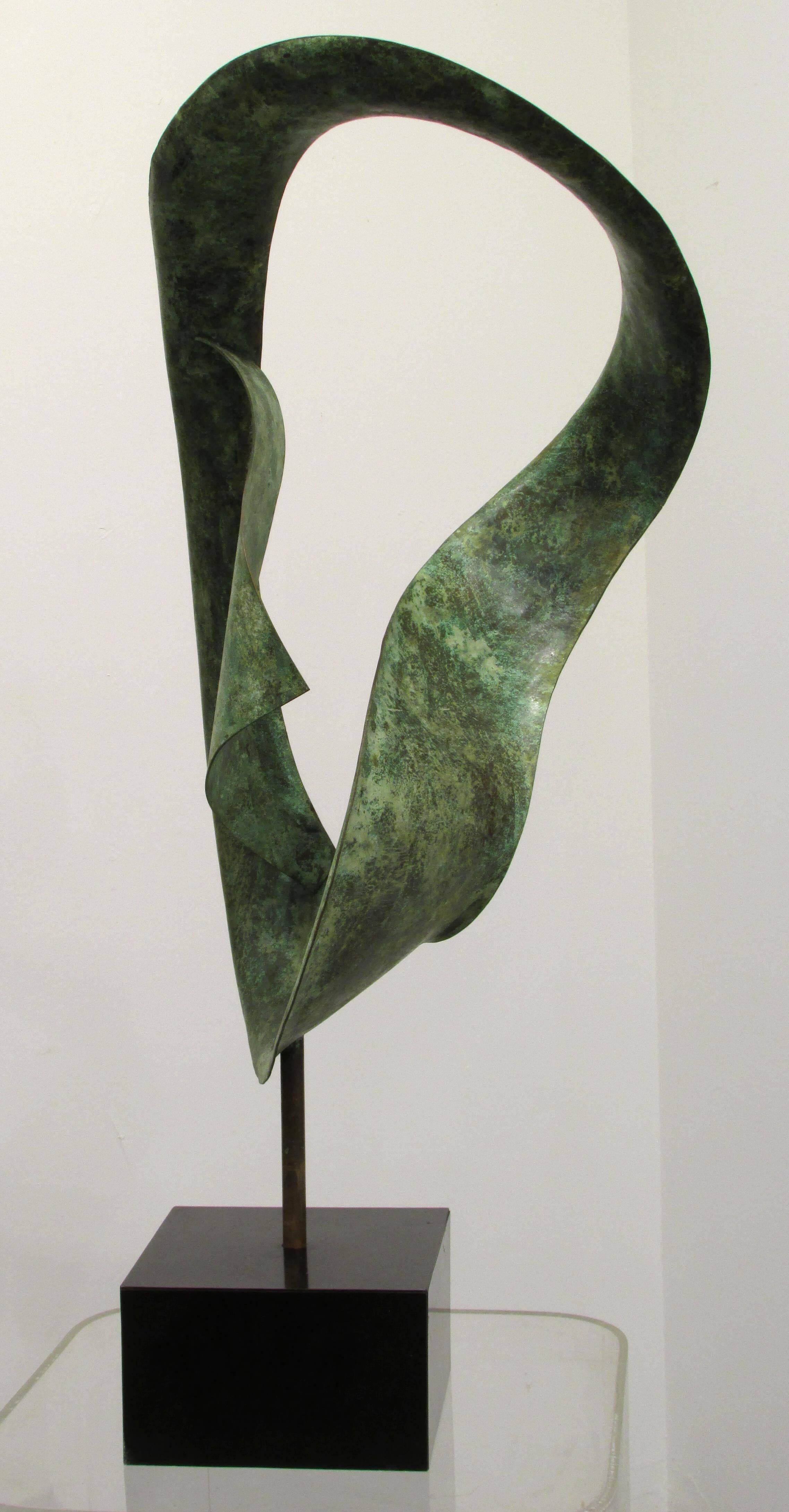 Hand-hammered abstract copper sculpture with patina on a black base sculpture is inserted into base and can turn.