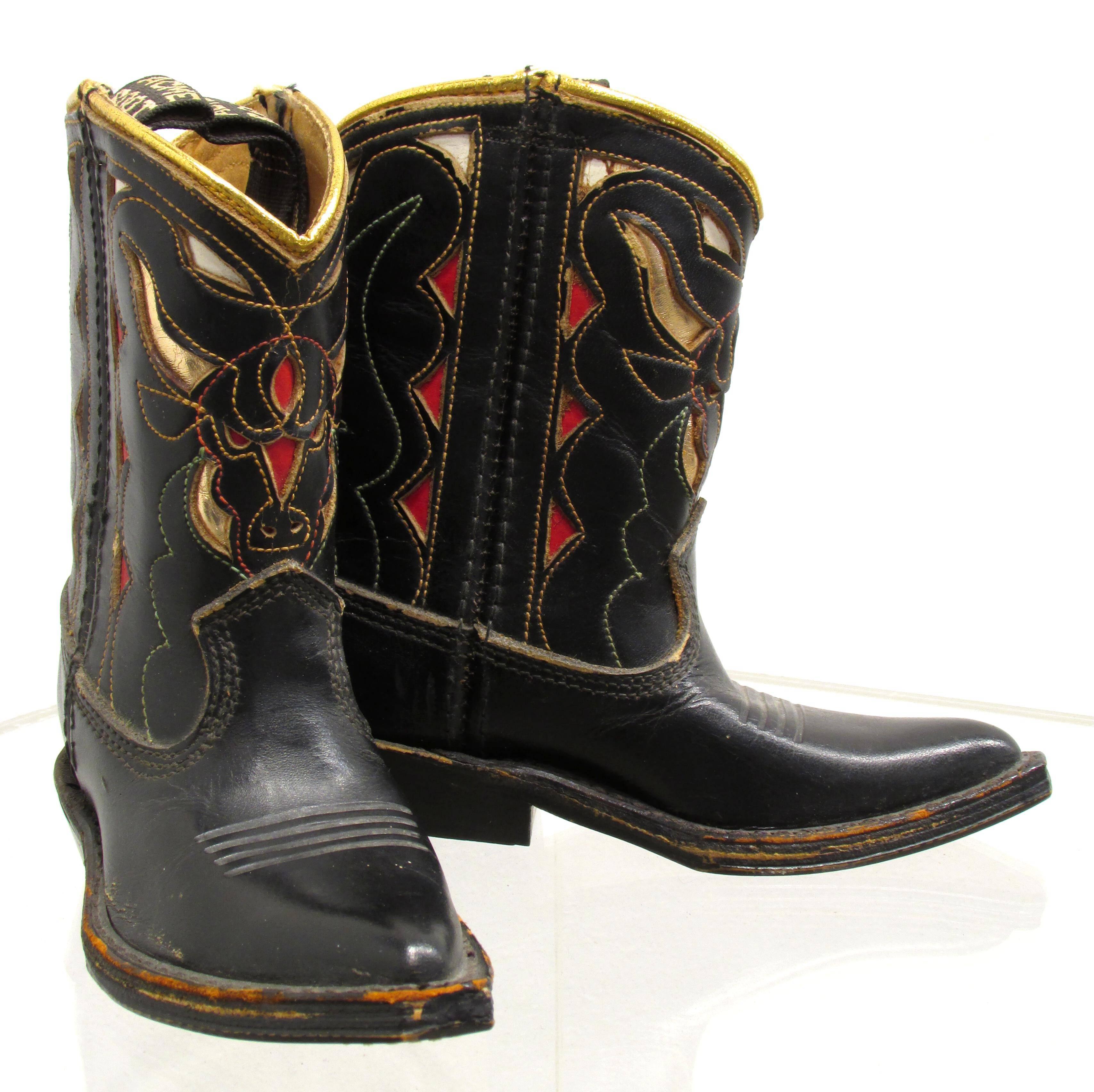 Pair of miniature Acme cowboy boots used as a promotional or salesman sample marked on the bottom of one.