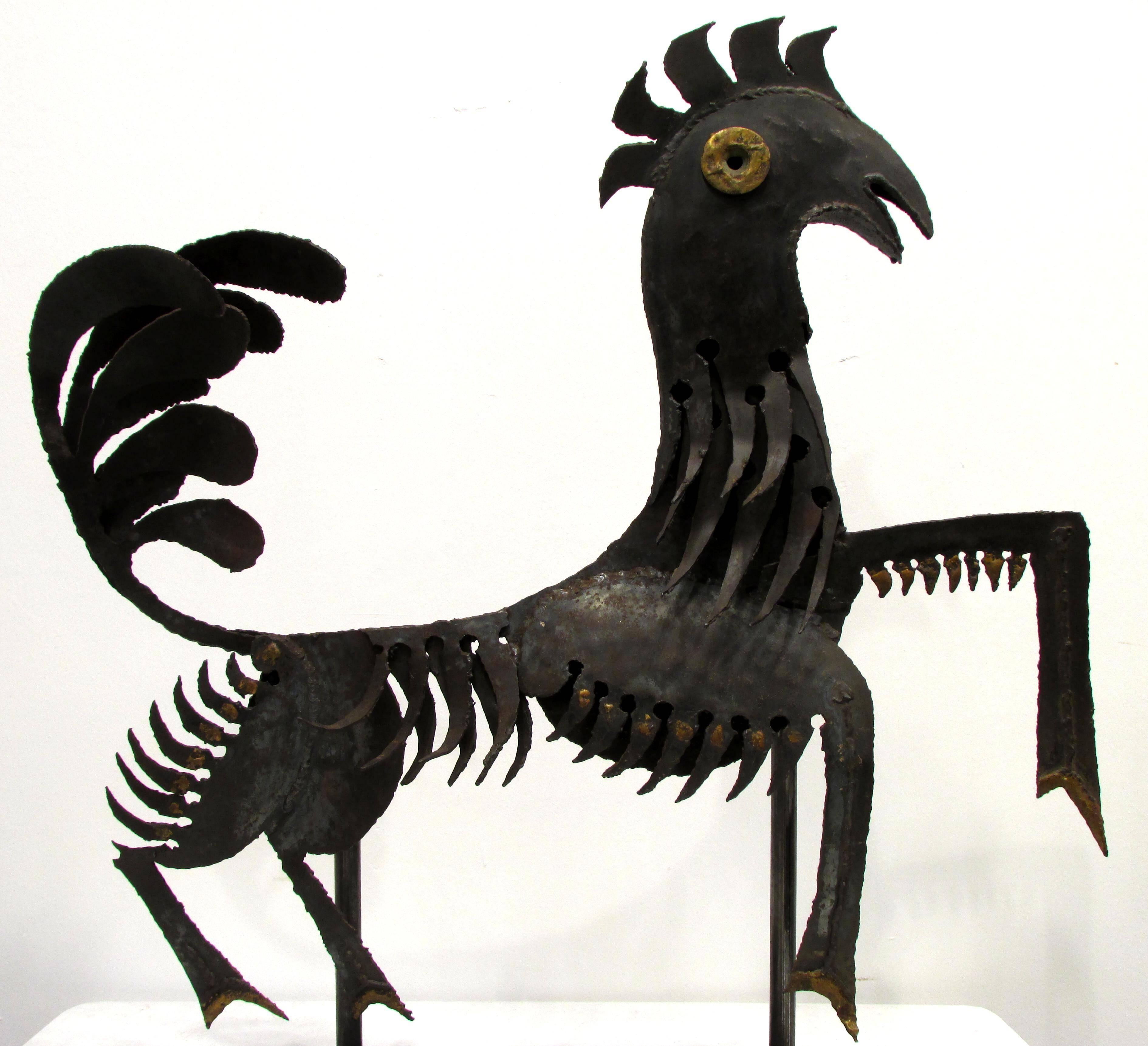 Torch cut metal sculpture of a rooster goat mix mythical figure with bronze brazed accents from Haiti mounted on new metal stand.