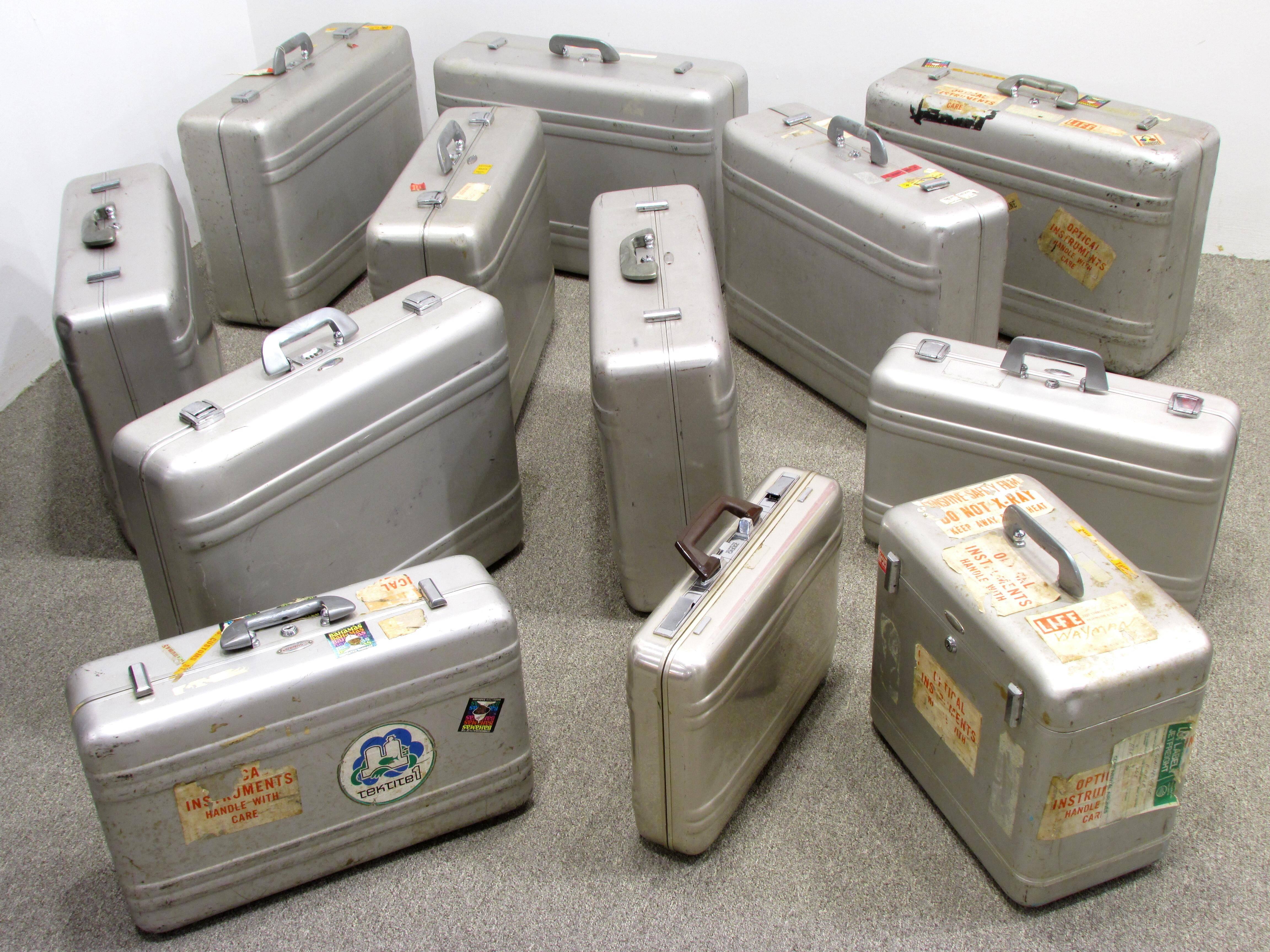 Collection of twelve aluminium suitcases made by Zero Halliburton some bearing travel and "LIFE" magazine stickers sizes vary.