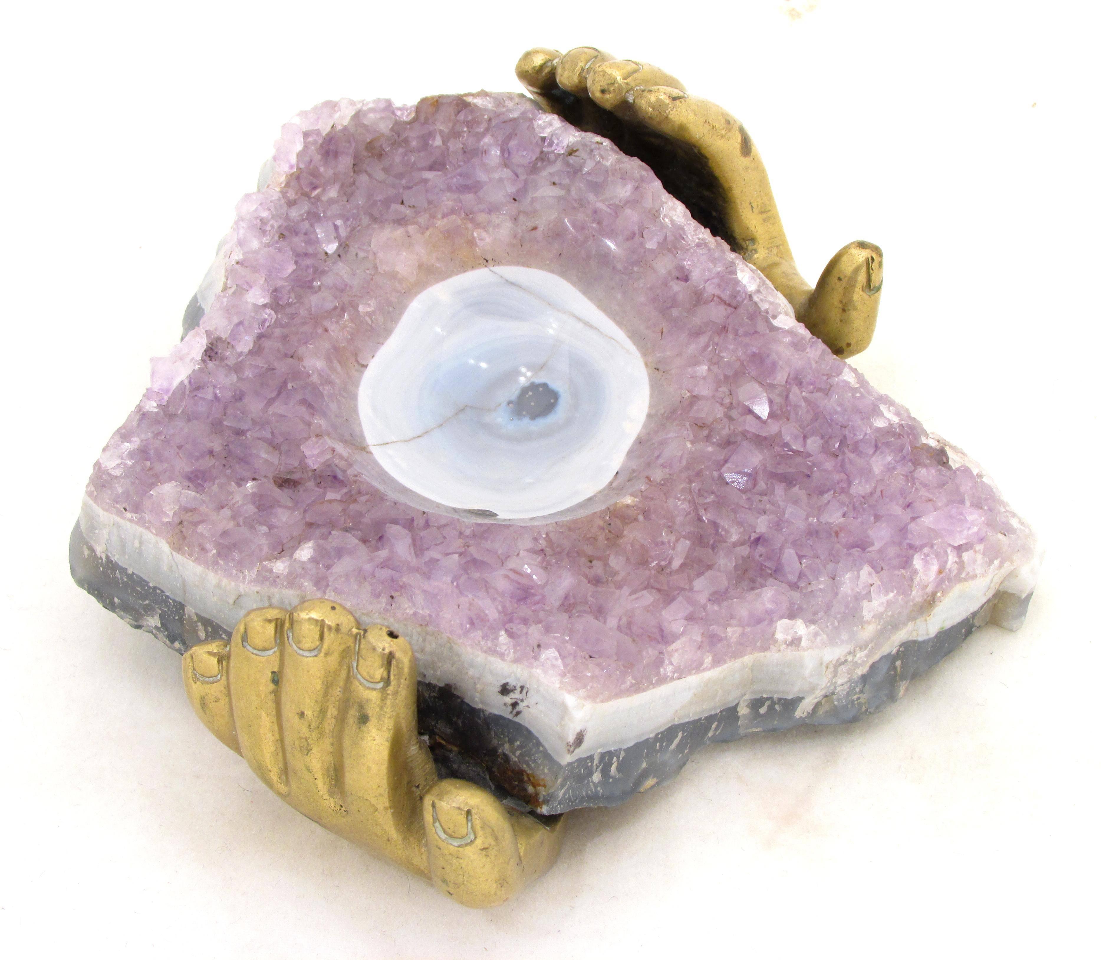 Beautiful small hollowed out piece of Amethyst supported by two brass hands signed 
