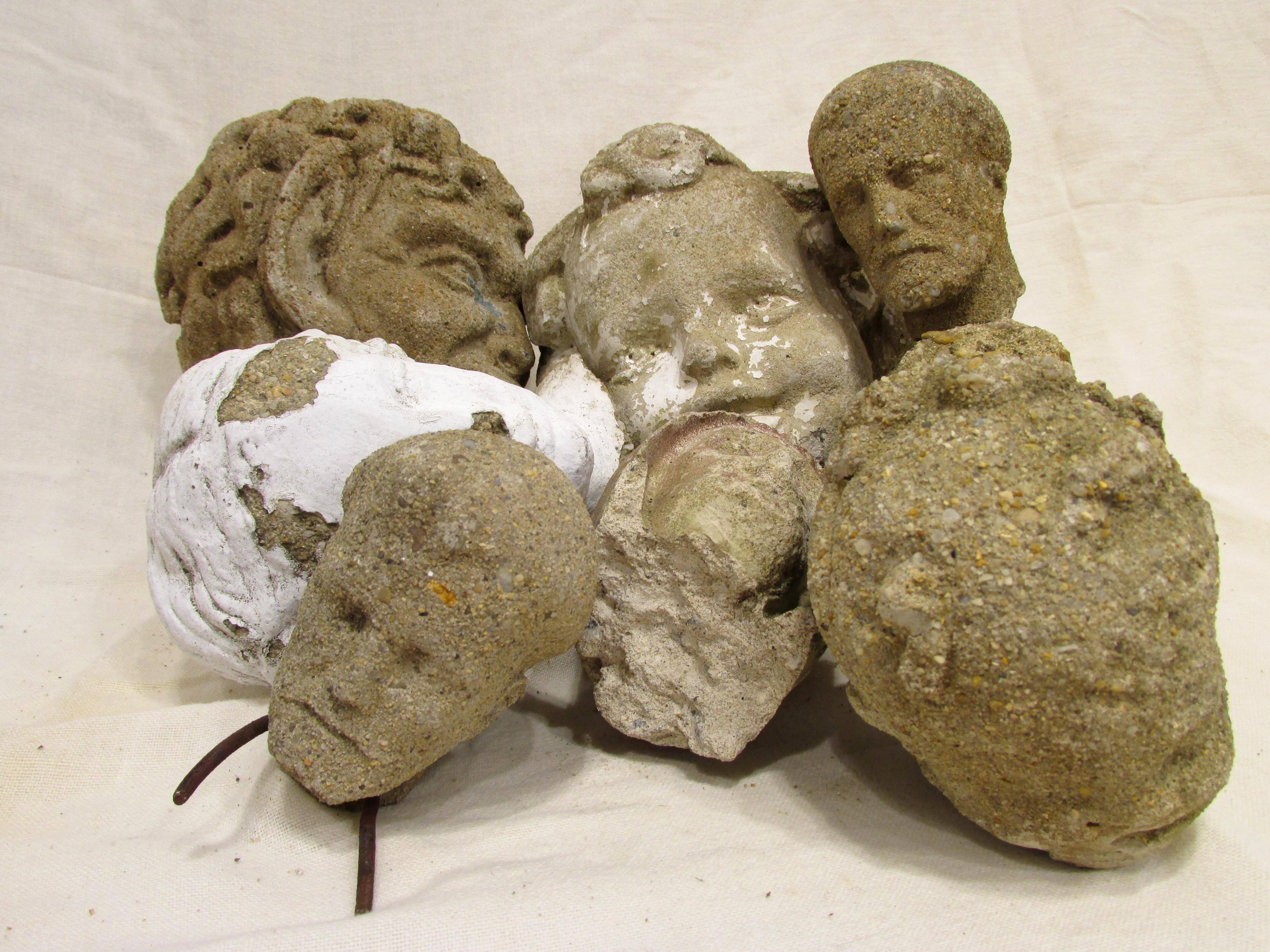 Pile of eight cast stone heads from various statues makes great display for bowl or table.