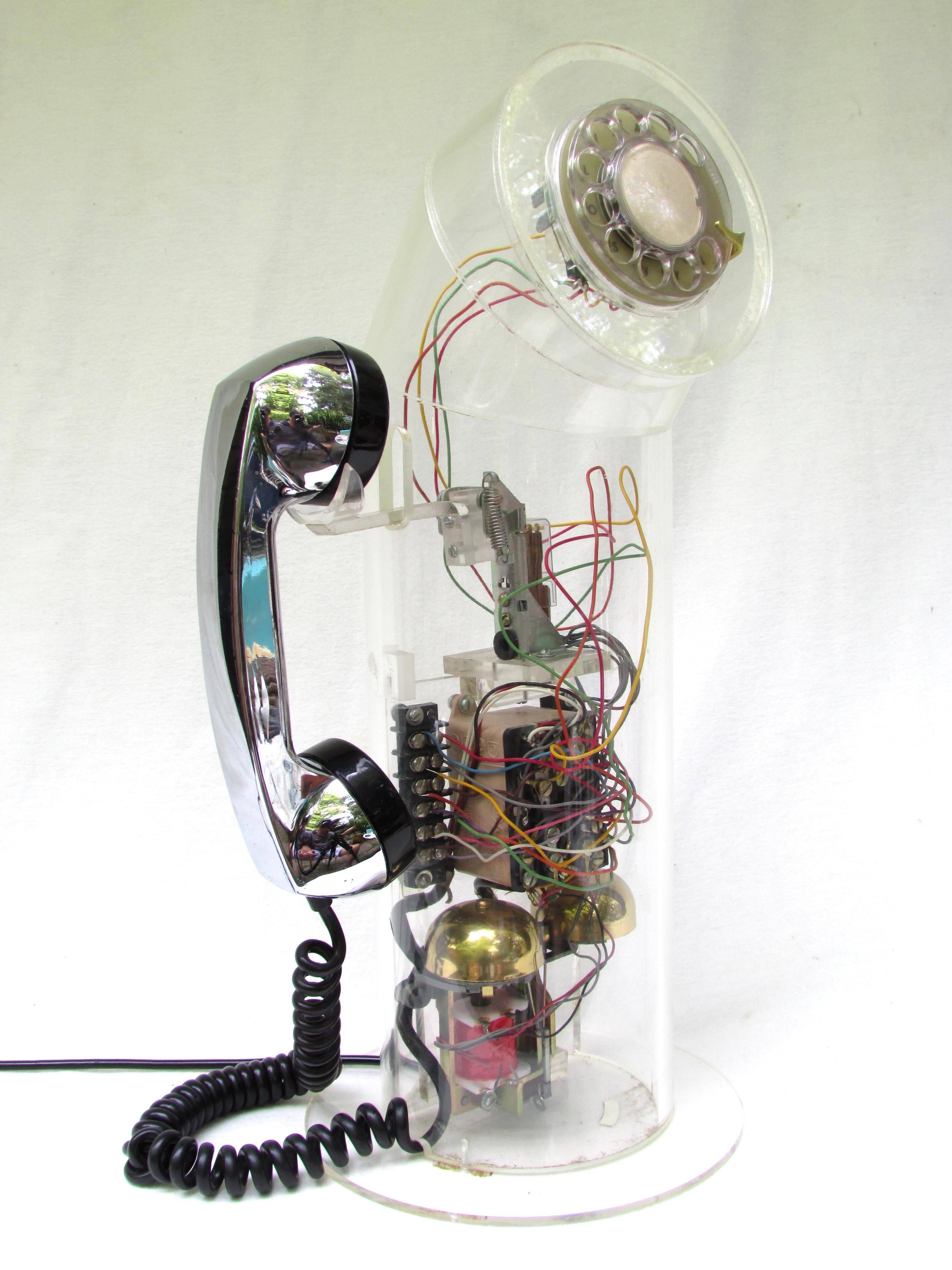 Vintage fascinating Lucite tube telephone with all the wires and bells exposed.