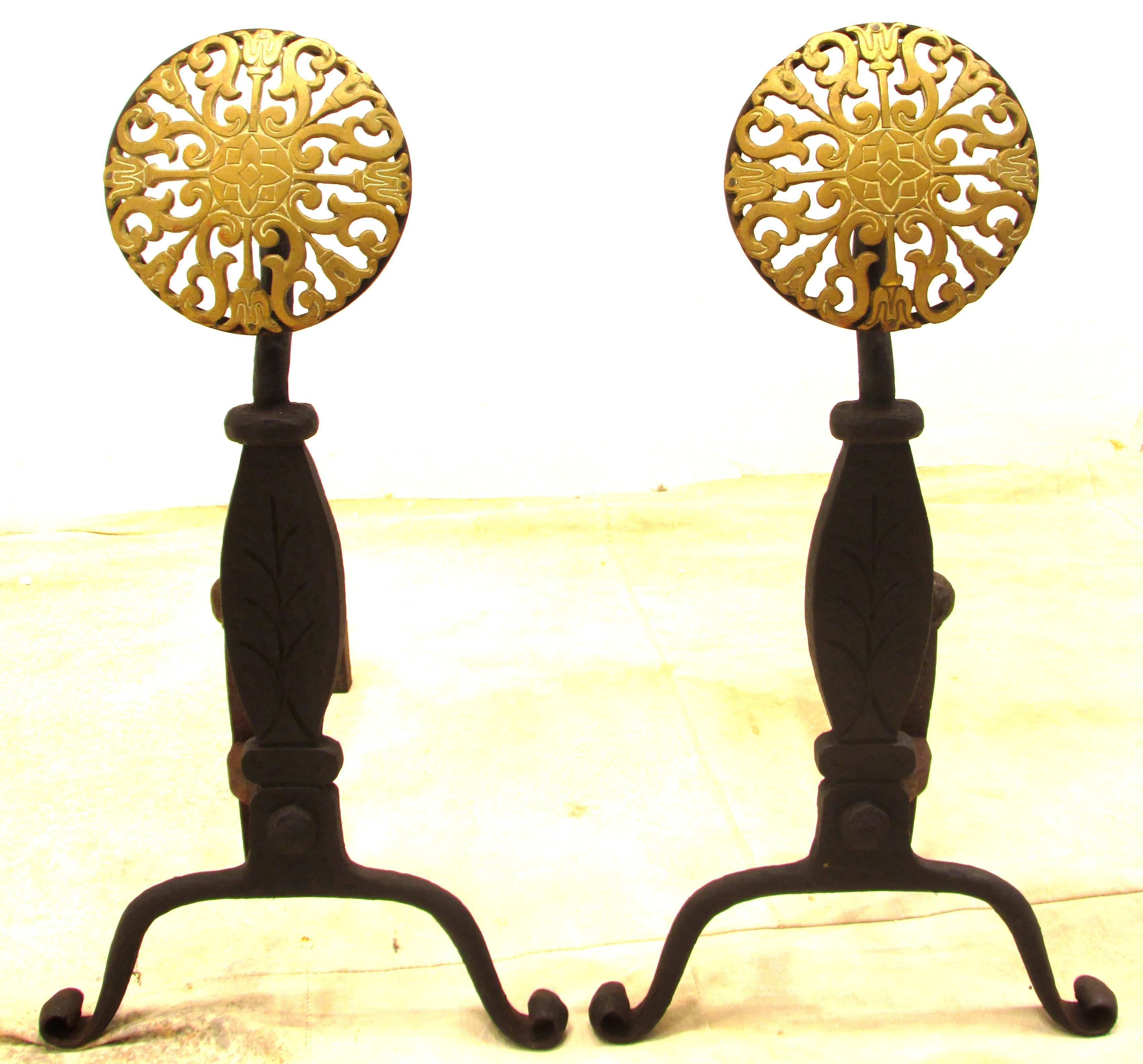 Pair of wrought iron andirons with large brass medallions by Virginia Metalcrafters.