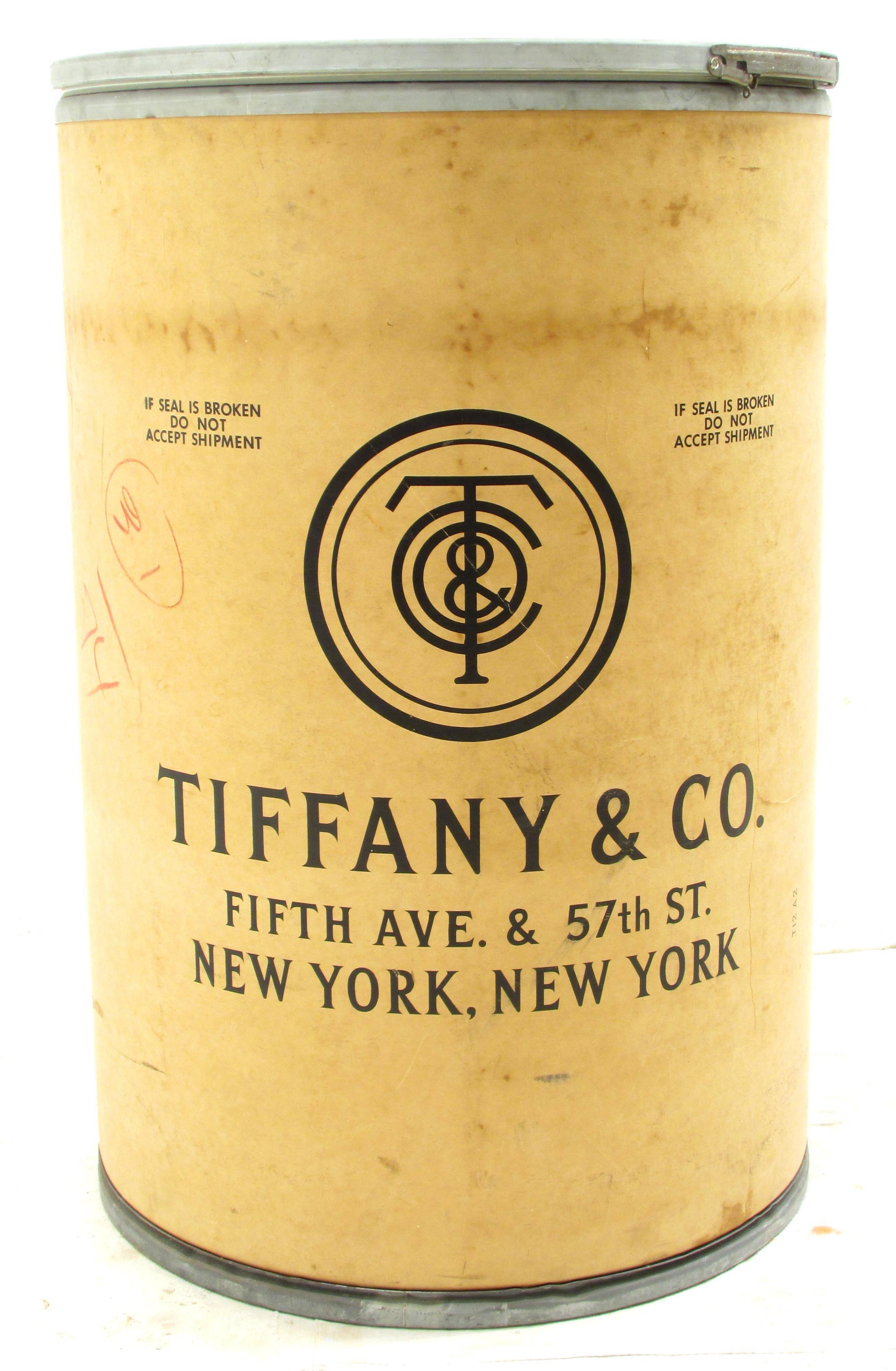 Beautiful worn and weathered 1958 vintage brown fiber barrel with Tiffany & Co. logo and address used to ship china to clients in the 1950s great to use as end table as well as storage.