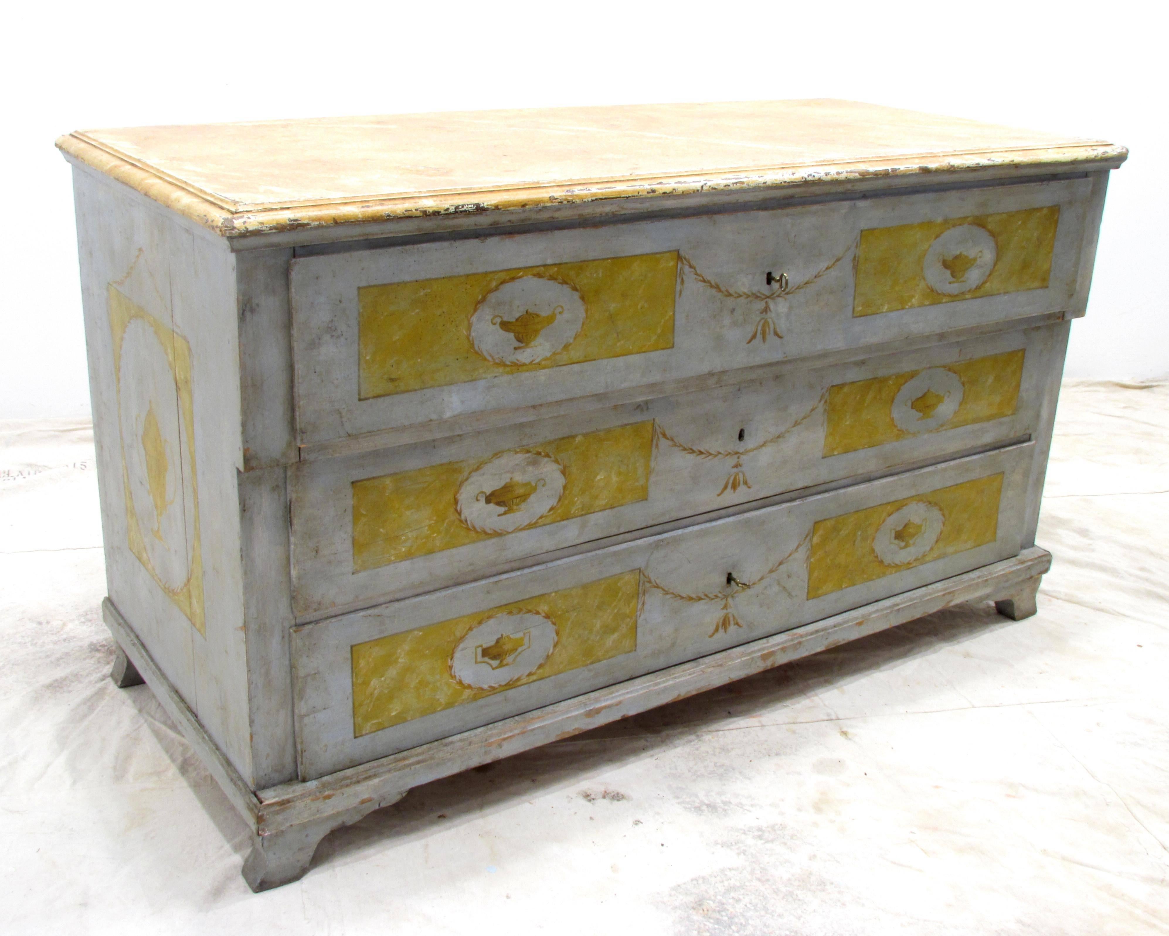 Beautifully painted large neoclassical chest of three drawers with urn and laurel swag motif with faux marble top.