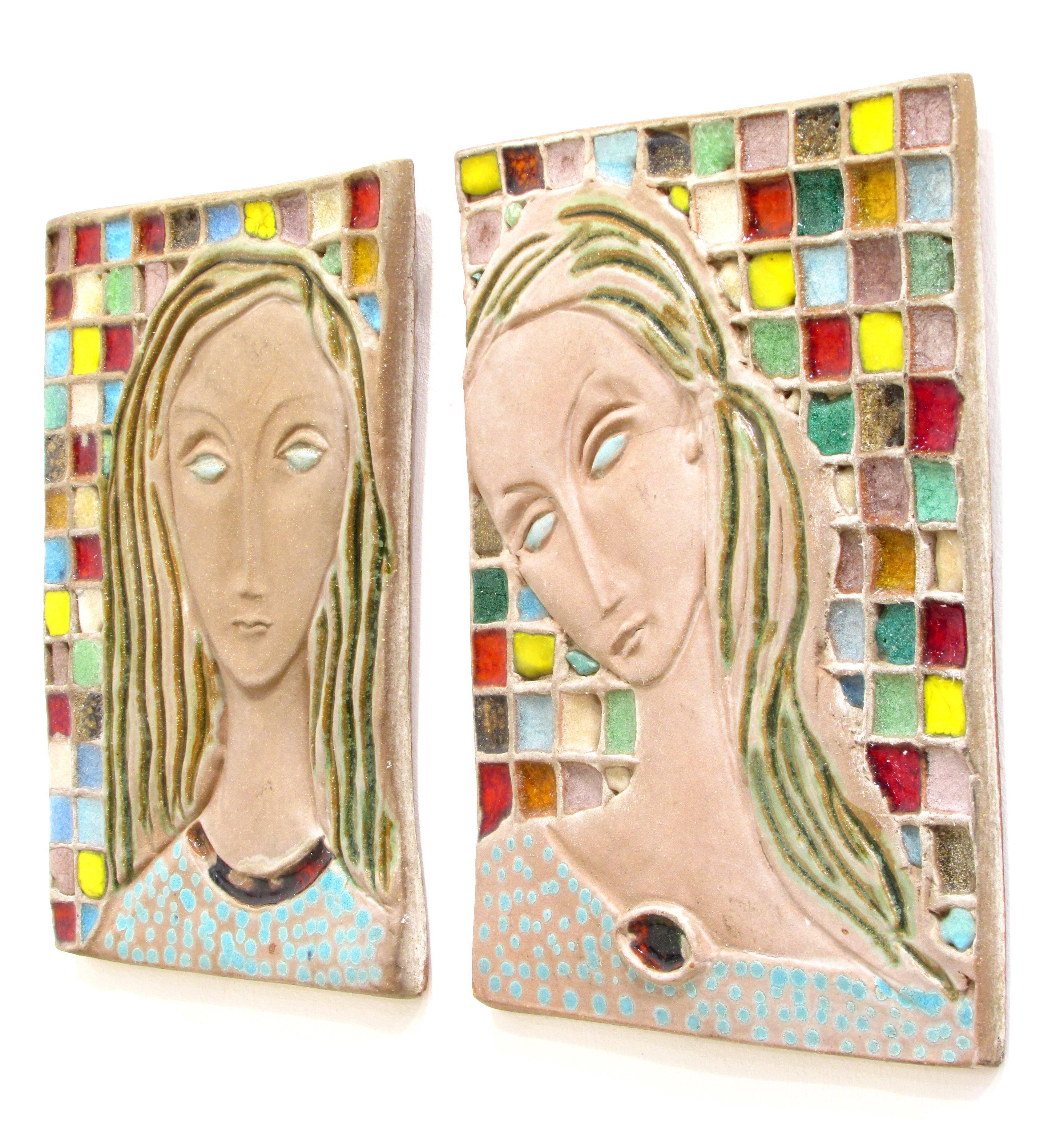 Incredible pair of sculpted and glazed terra cotta plaques of female figures with multi colored glazed 