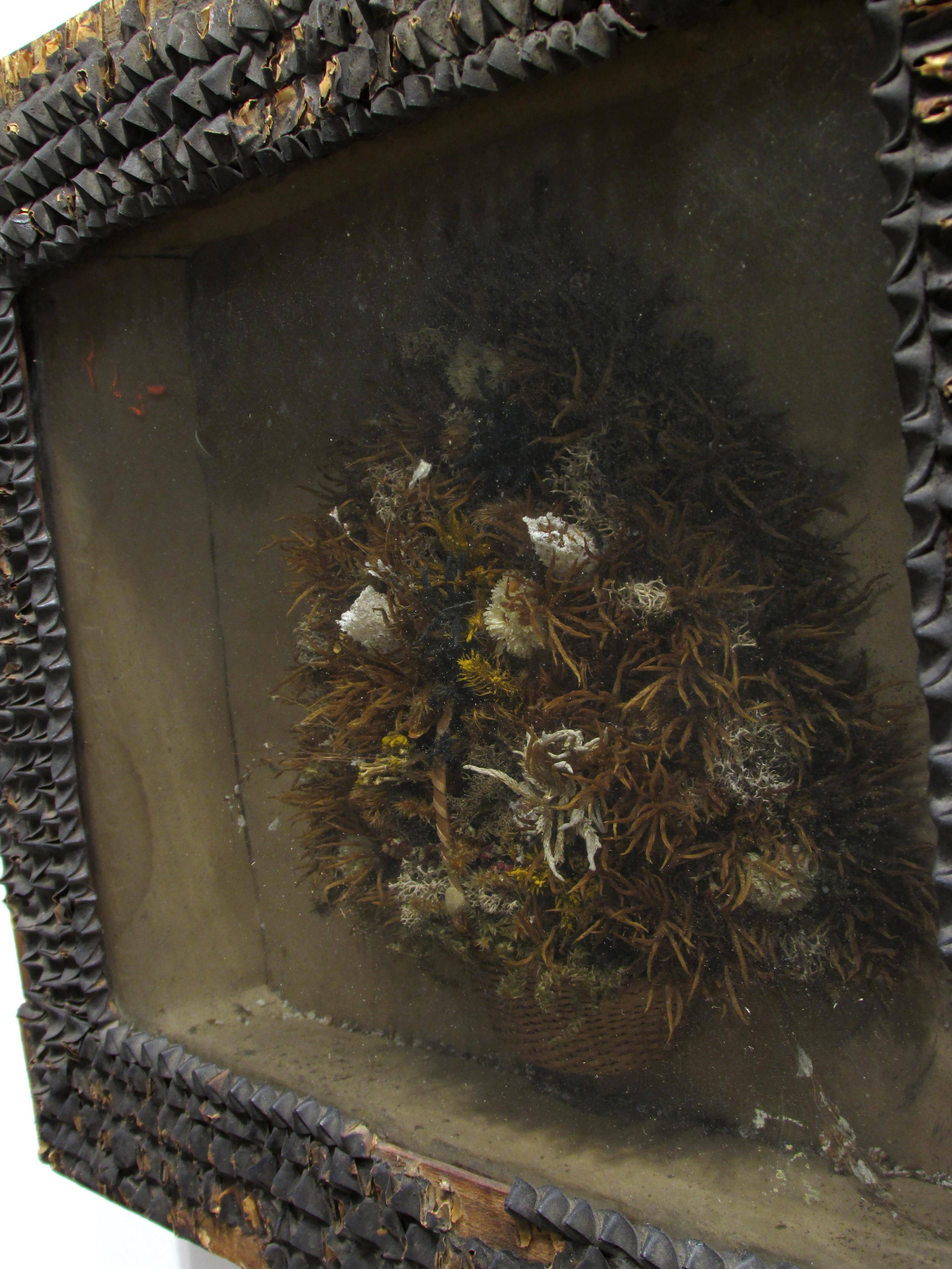 Beautiful very old antique dried flower arrangement in basket framed diorama with old seed pods on frame with old wallpaper on back this is a great piece of early Folk Art with old poured bubbled glass.