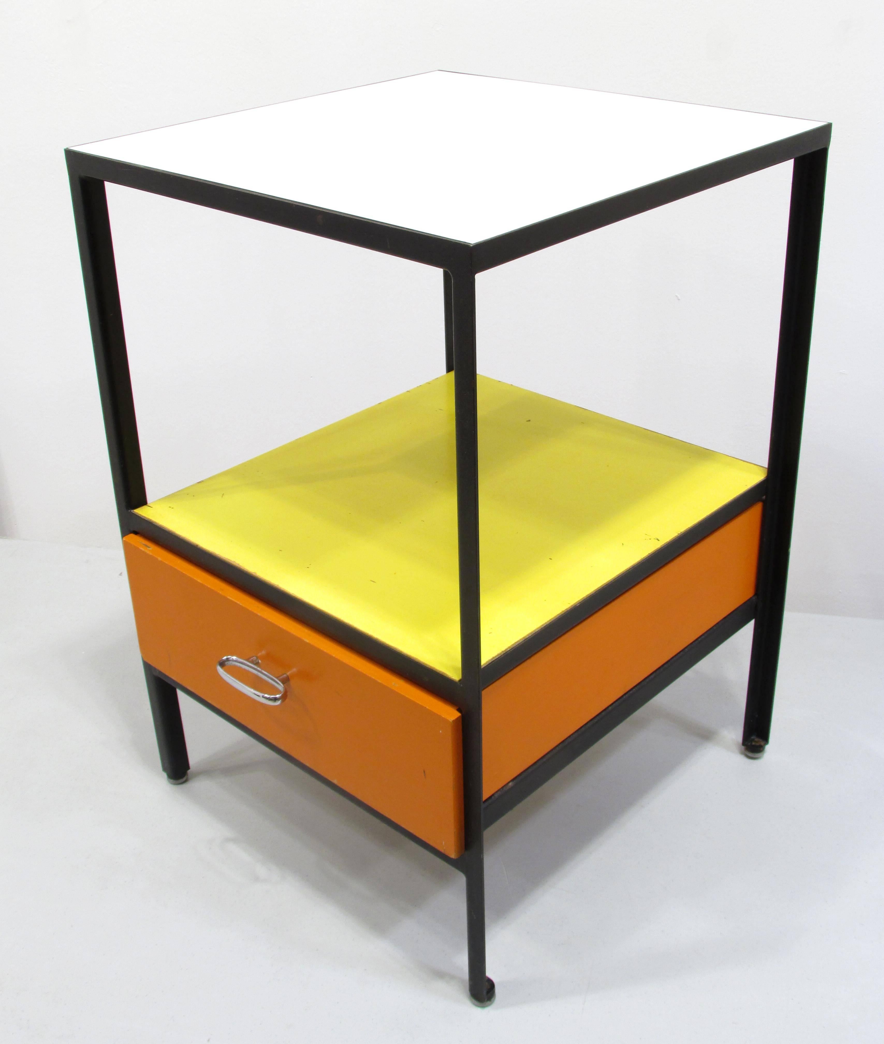 Early original colors and condition side table or night stand from the Steel Frame series designed by George Nelson for Herman Miller black frame with orange drawer and yellow lower top with a white upper top