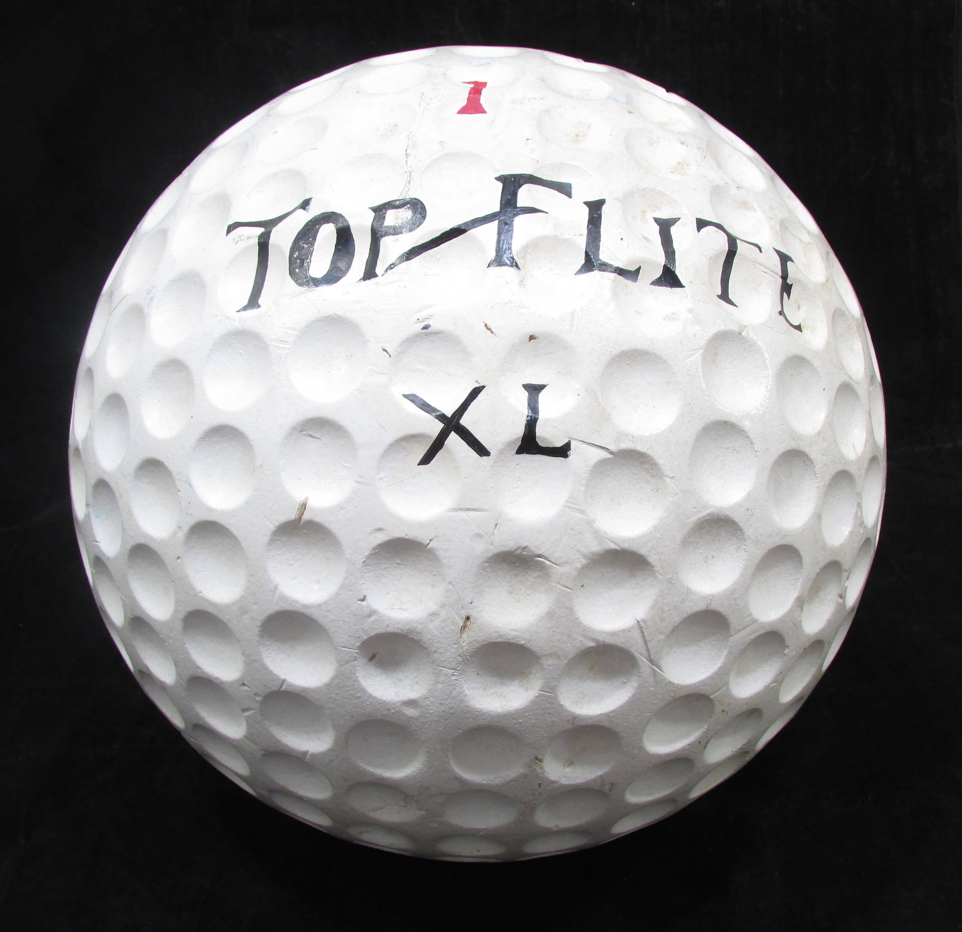 Large-scale golf ball used as a store prop trade sign made of cast hard foam.