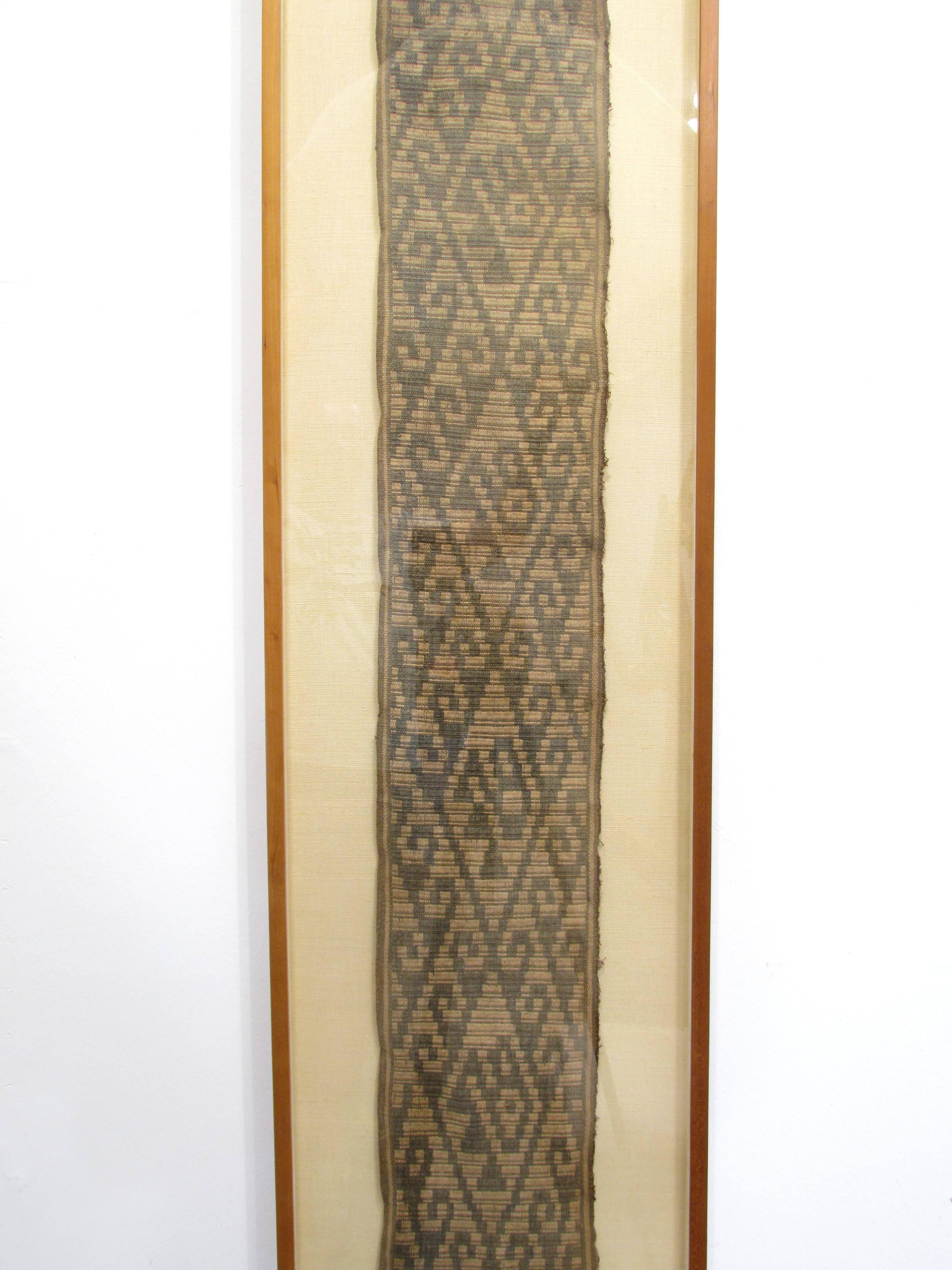 Beautiful framed long Pre-Columbian fabric can be hung vertically or horizontally.