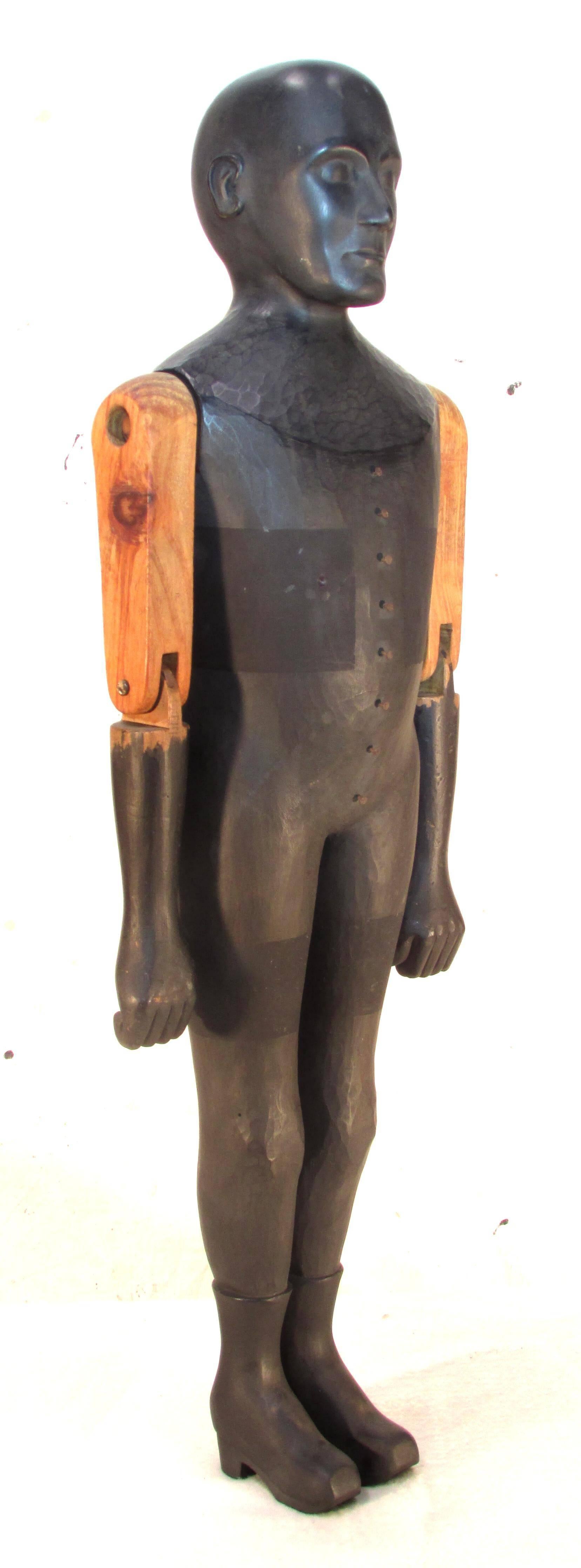 Carved and painted wooden sculpture with articulated arms by contemporary folk artist Mark A. Perry titled 
