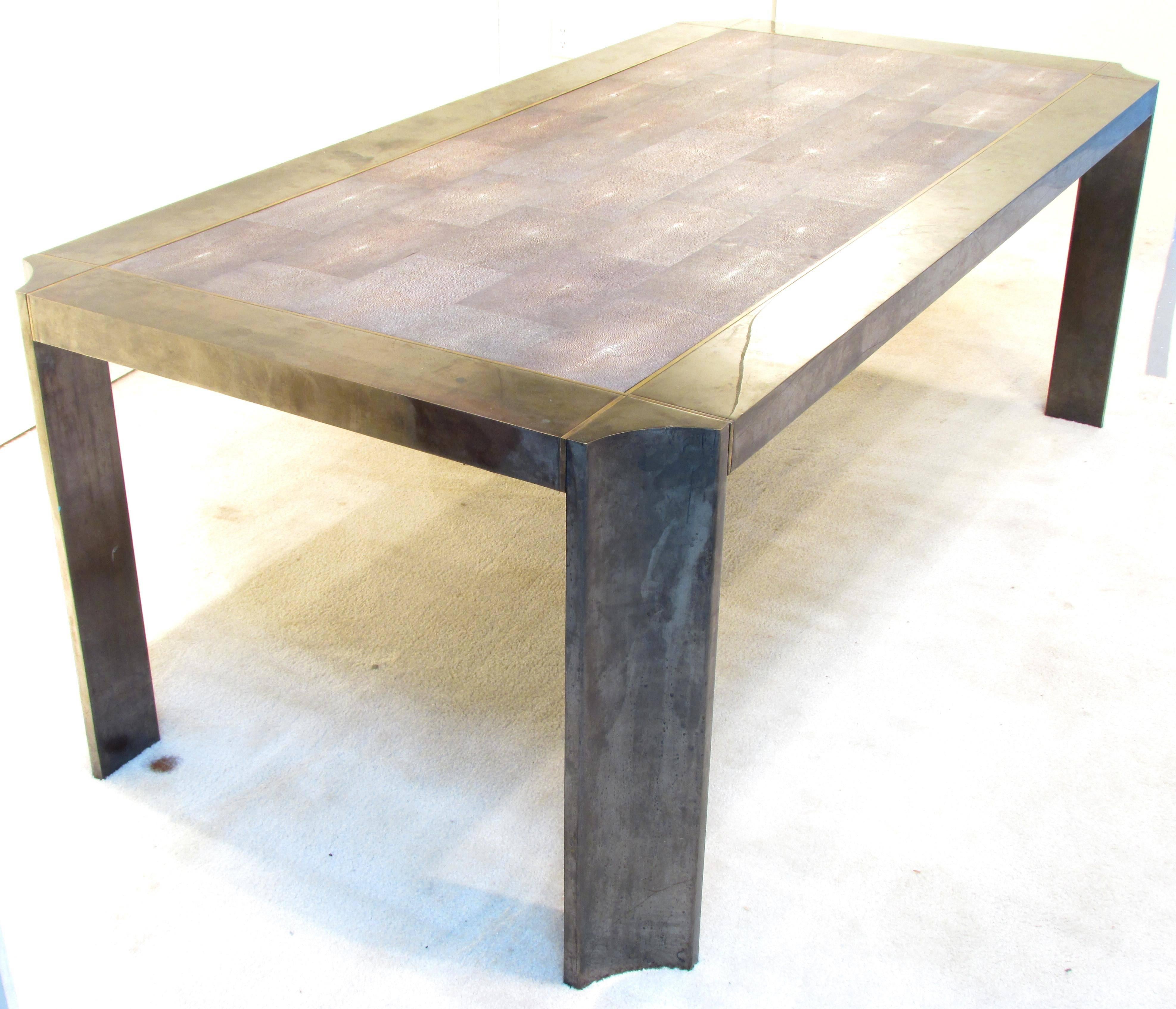 Beautiful dining table with polished gunmetal legs with bronze insets with a shagreen covered inset top by Karl Springer.