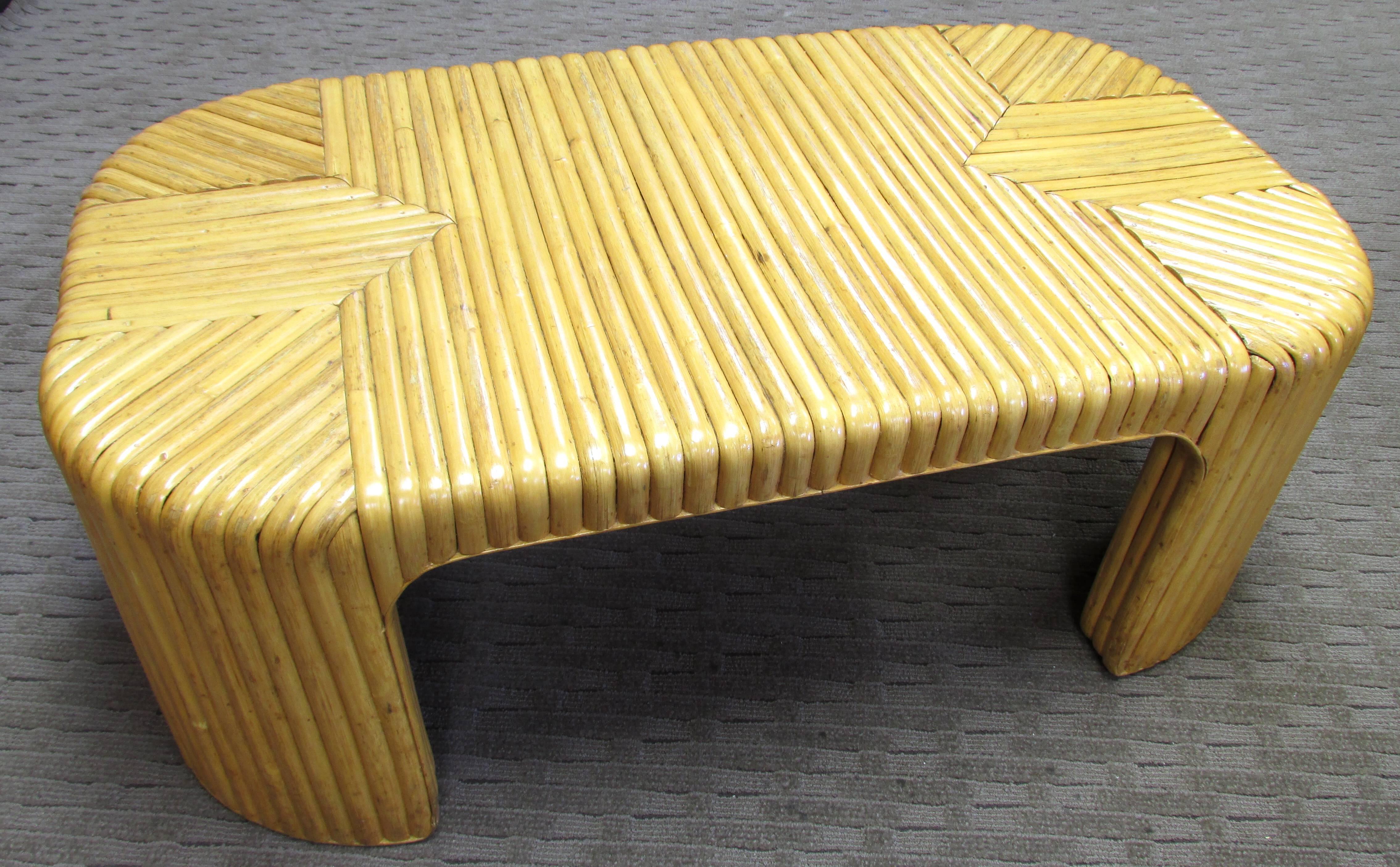 Nice oblong coffee table covered with rattan in graphic pattern with rounded corners